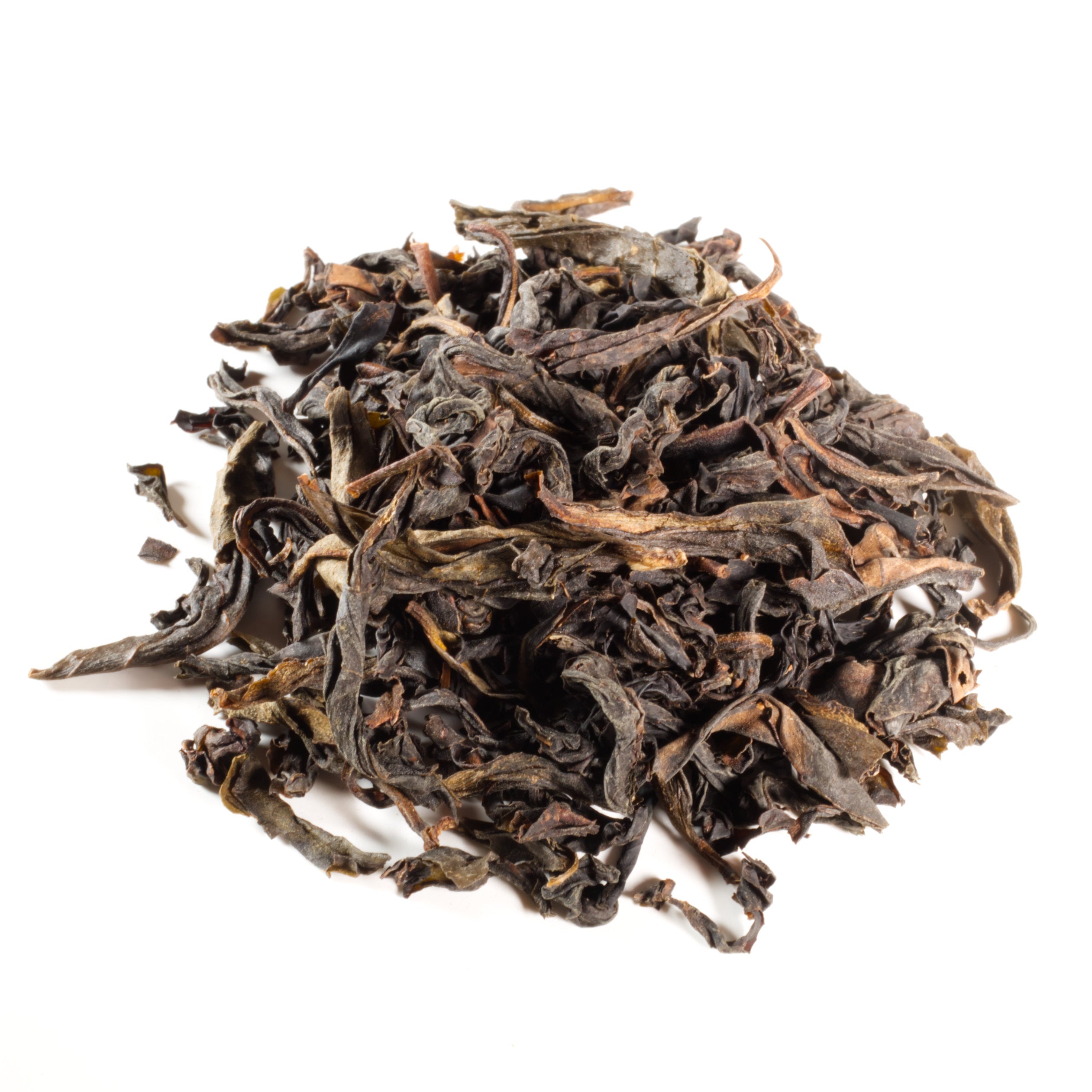Pile of dry black tea leaves on a white background