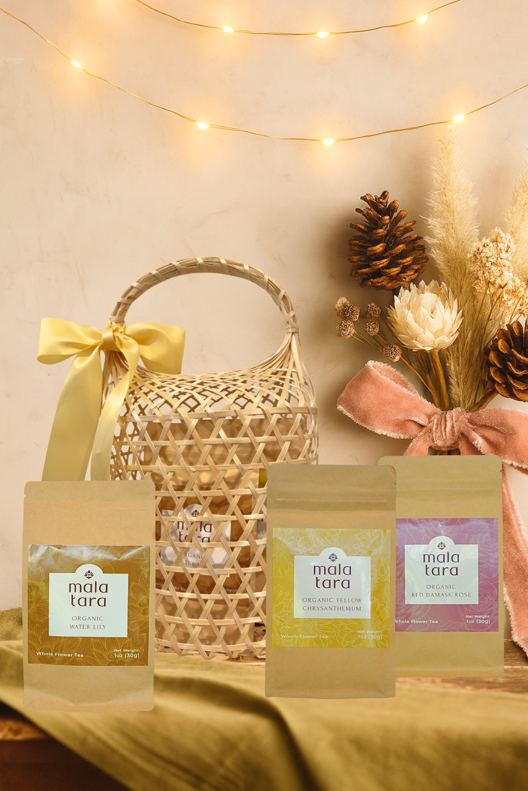 Gift basket with 'maia tara' products against a warm-toned background with string lights.