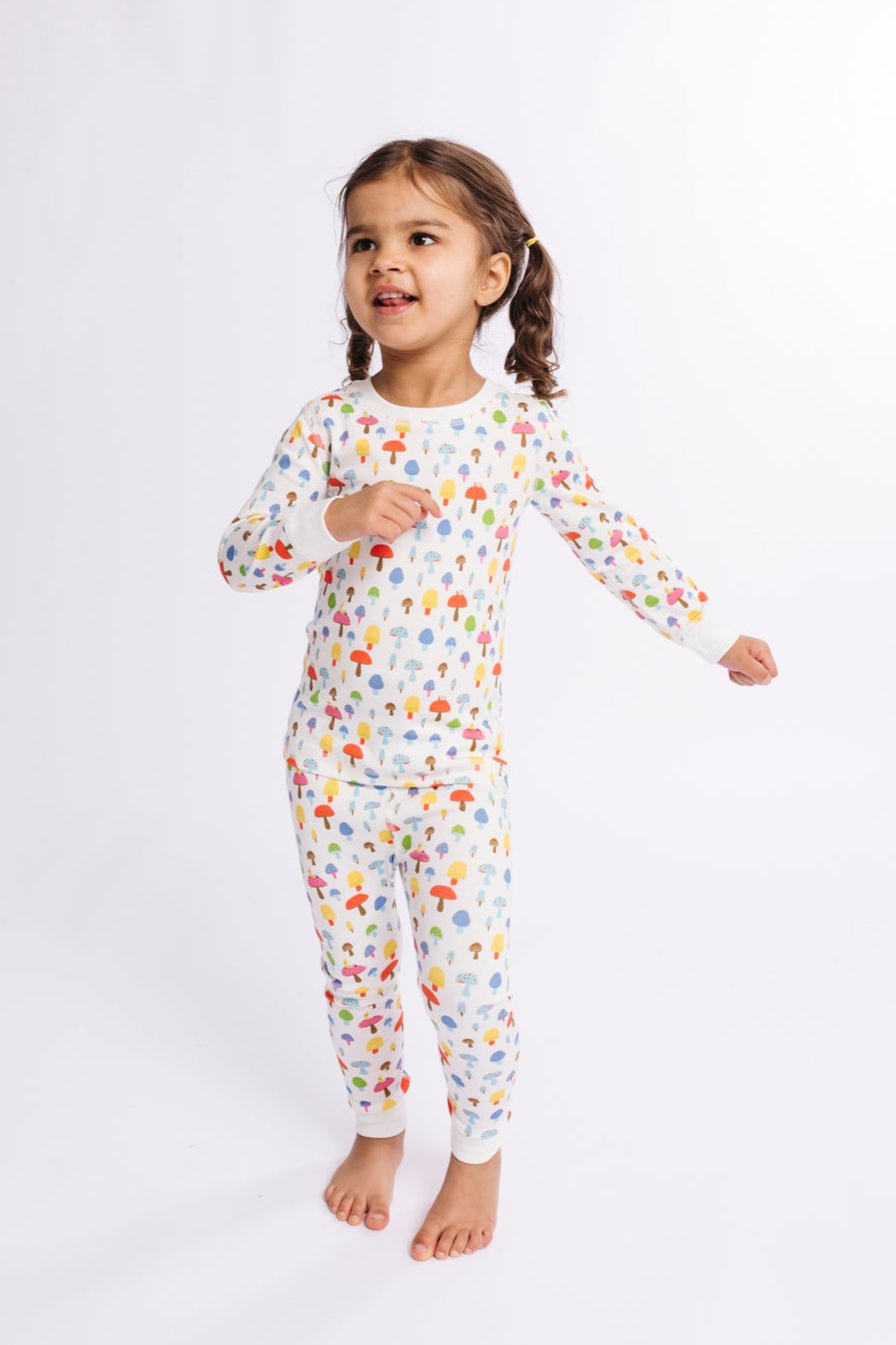 Child wearing a colorful pajama set on a white background