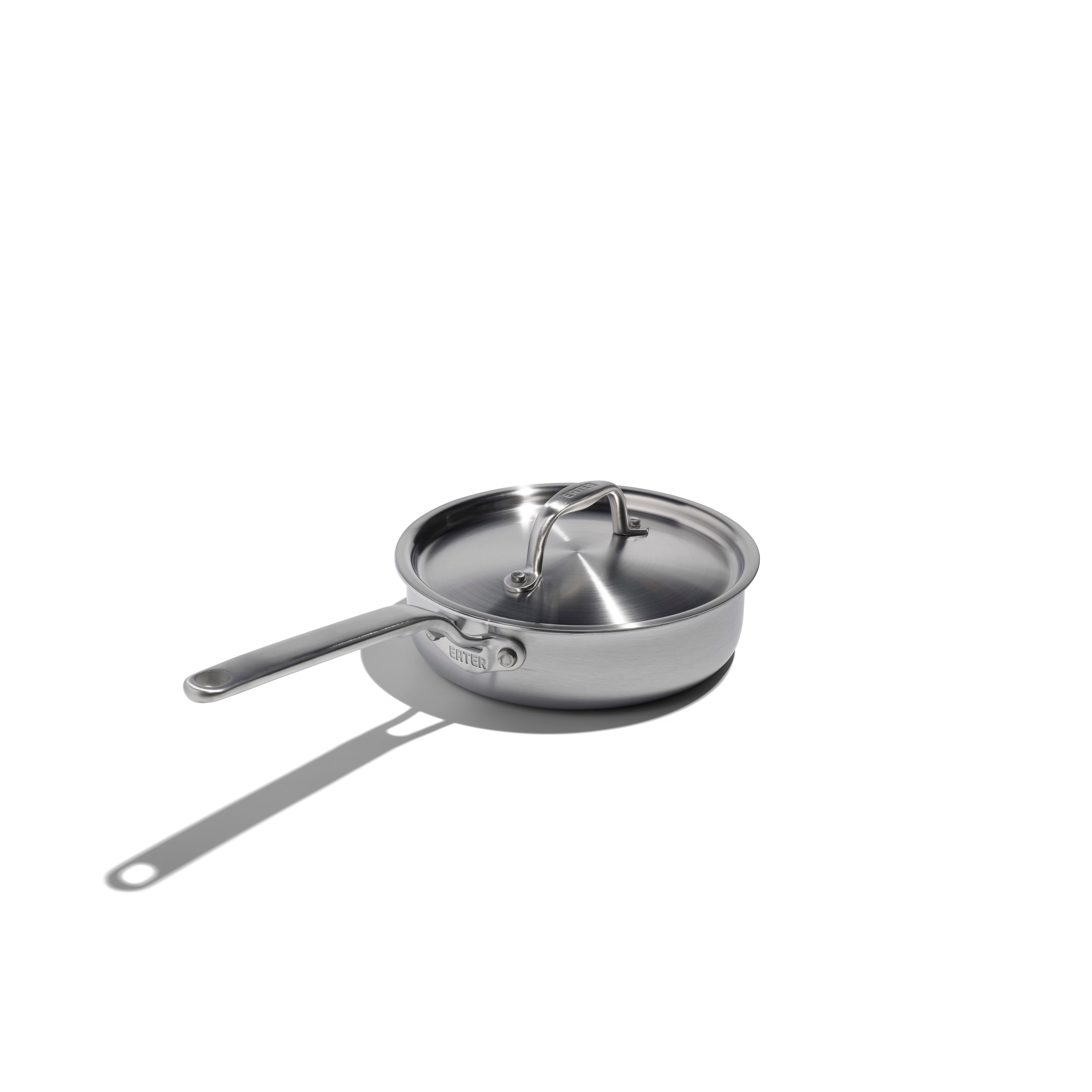 Stainless steel frying pan with lid on a white background