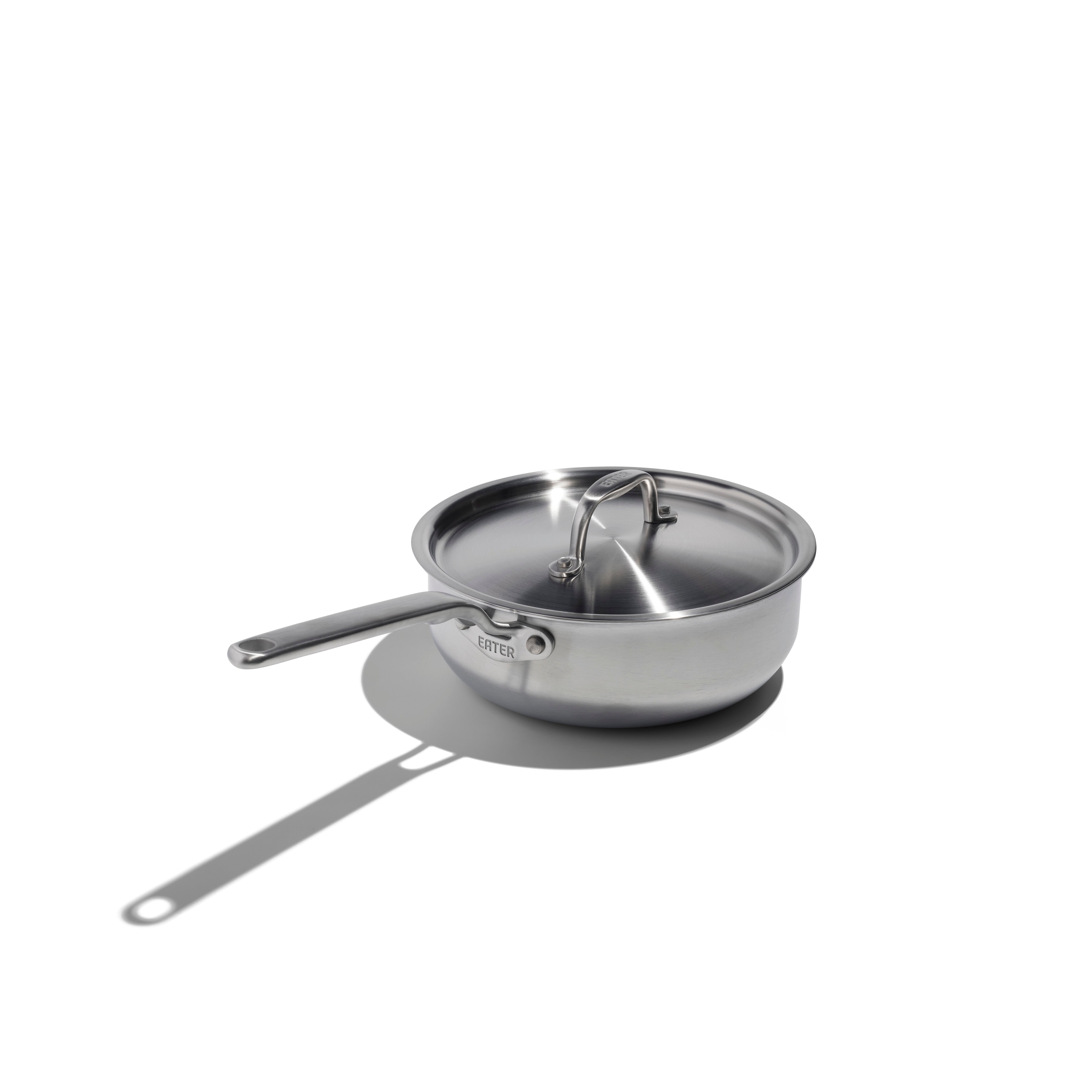 Stainless steel frying pan with lid on a white background