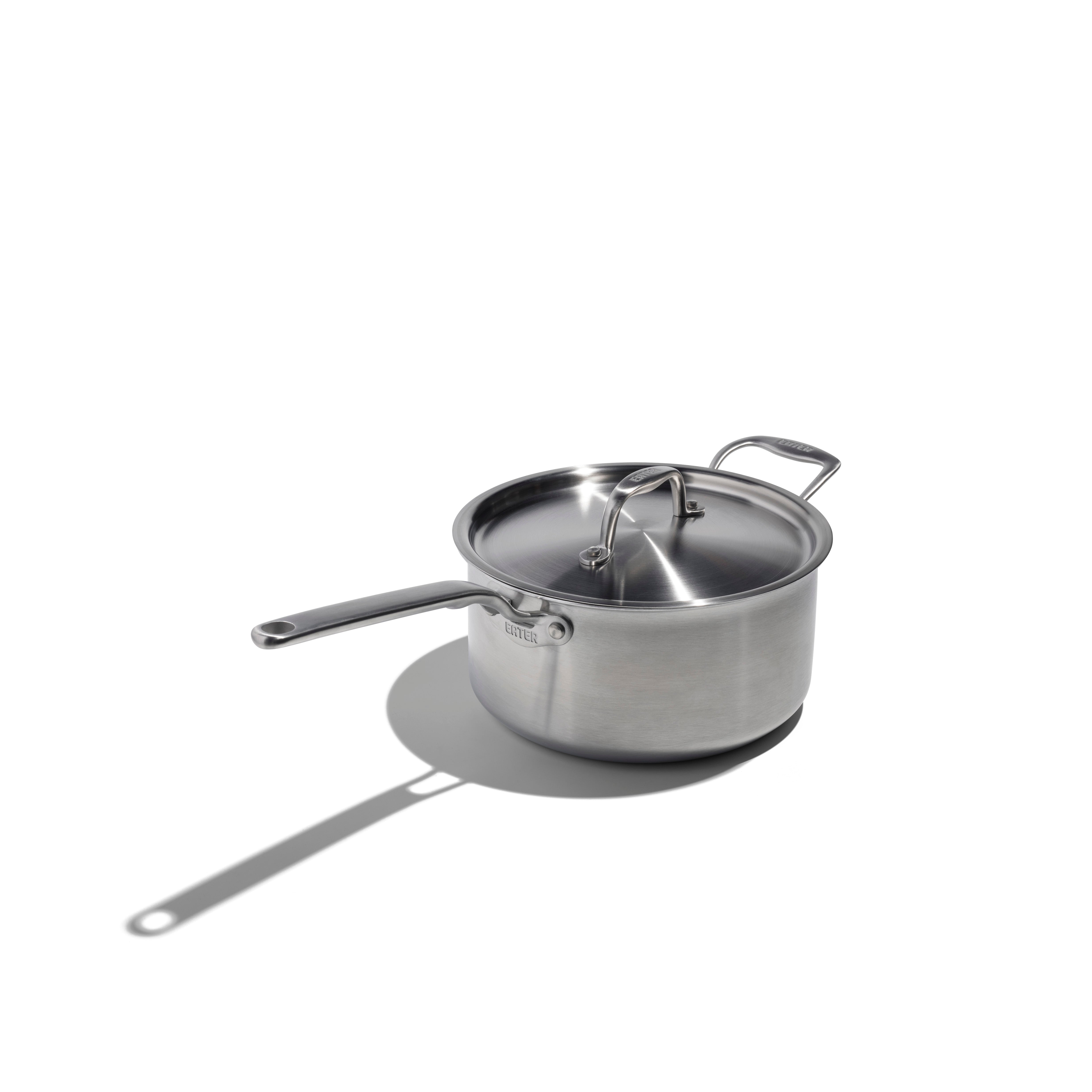 Stainless steel pot with lid on a white background