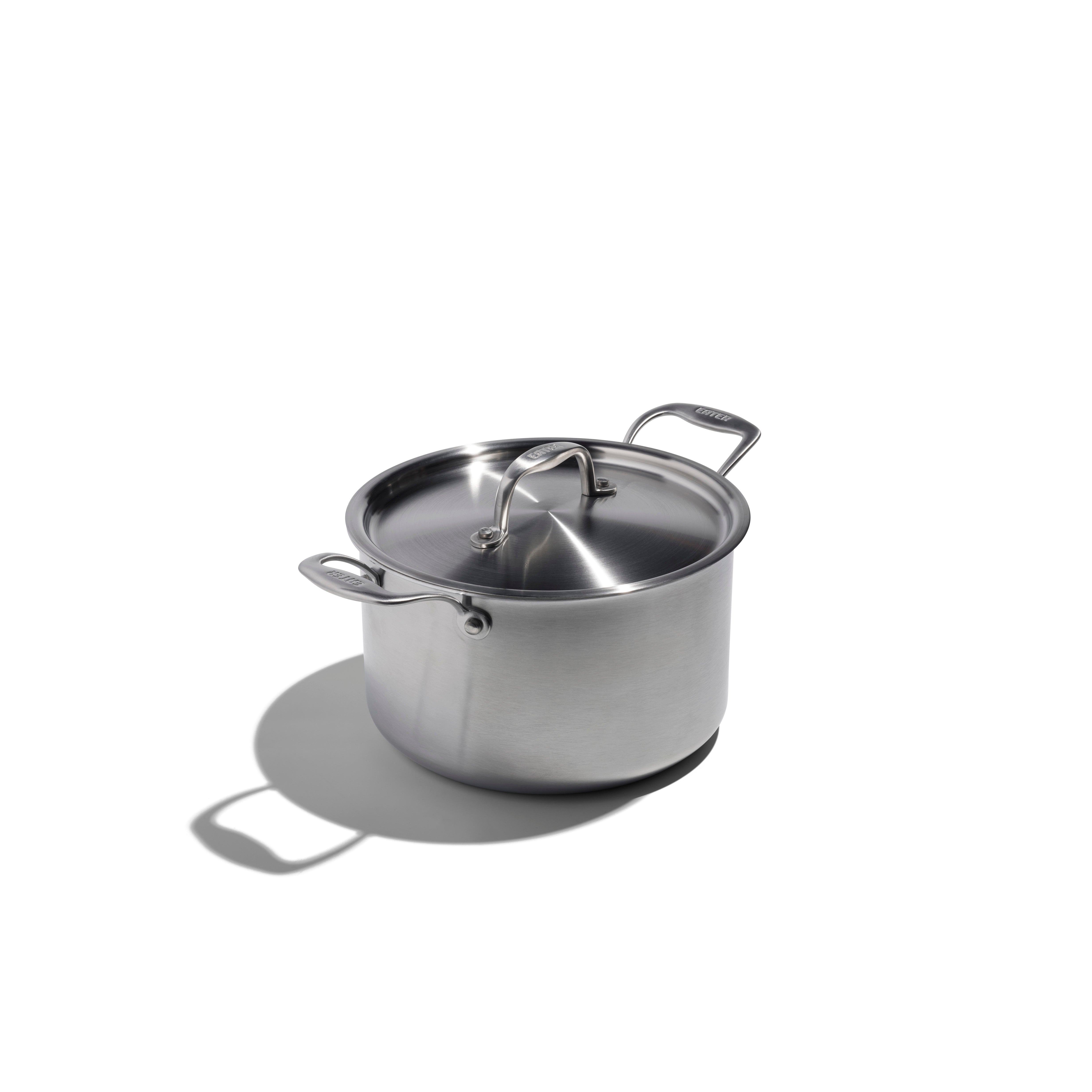 Stainless steel pot with lid on a white background