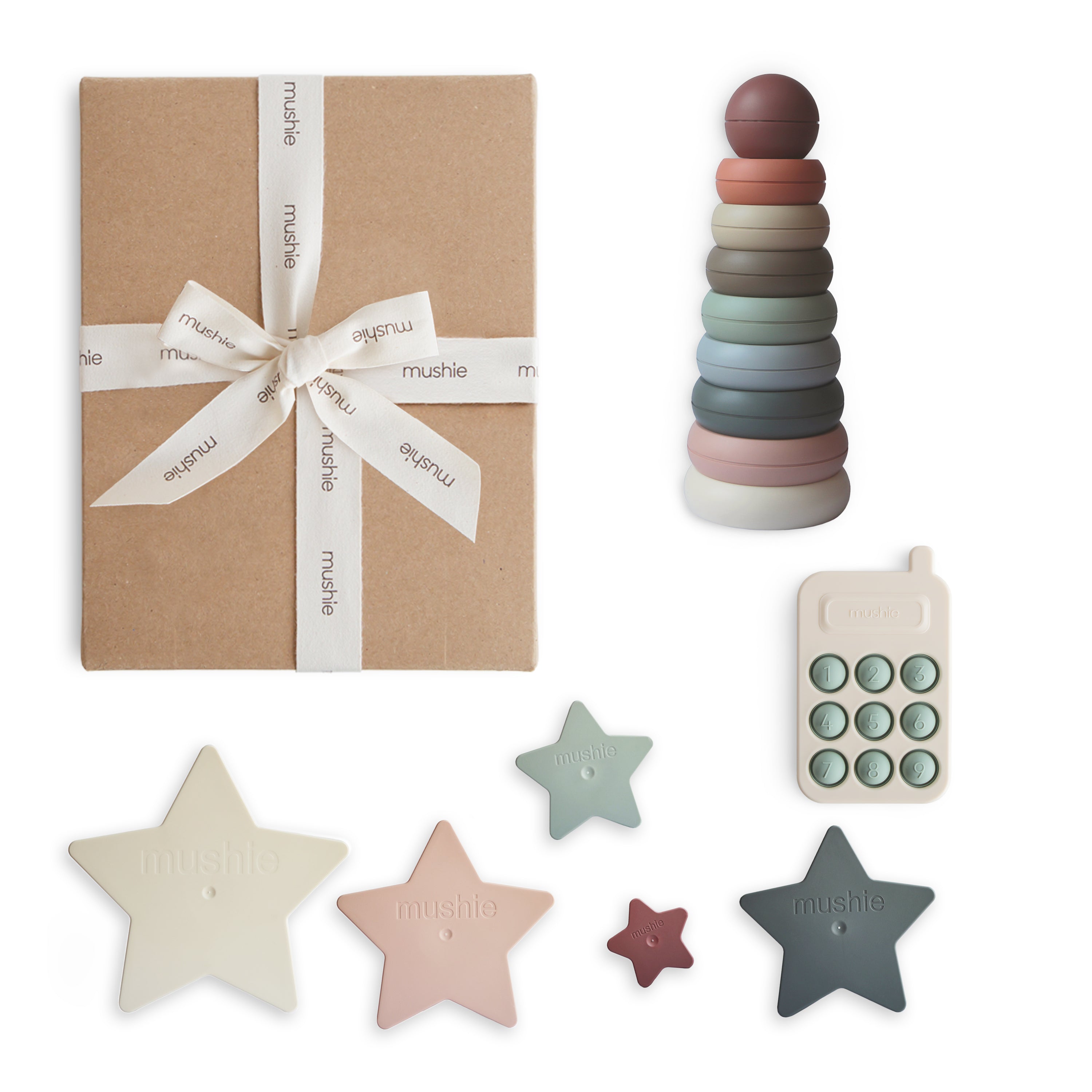 Set of colorful baby toys including a ring stacker, star-shaped items, and a toy phone on a white background.