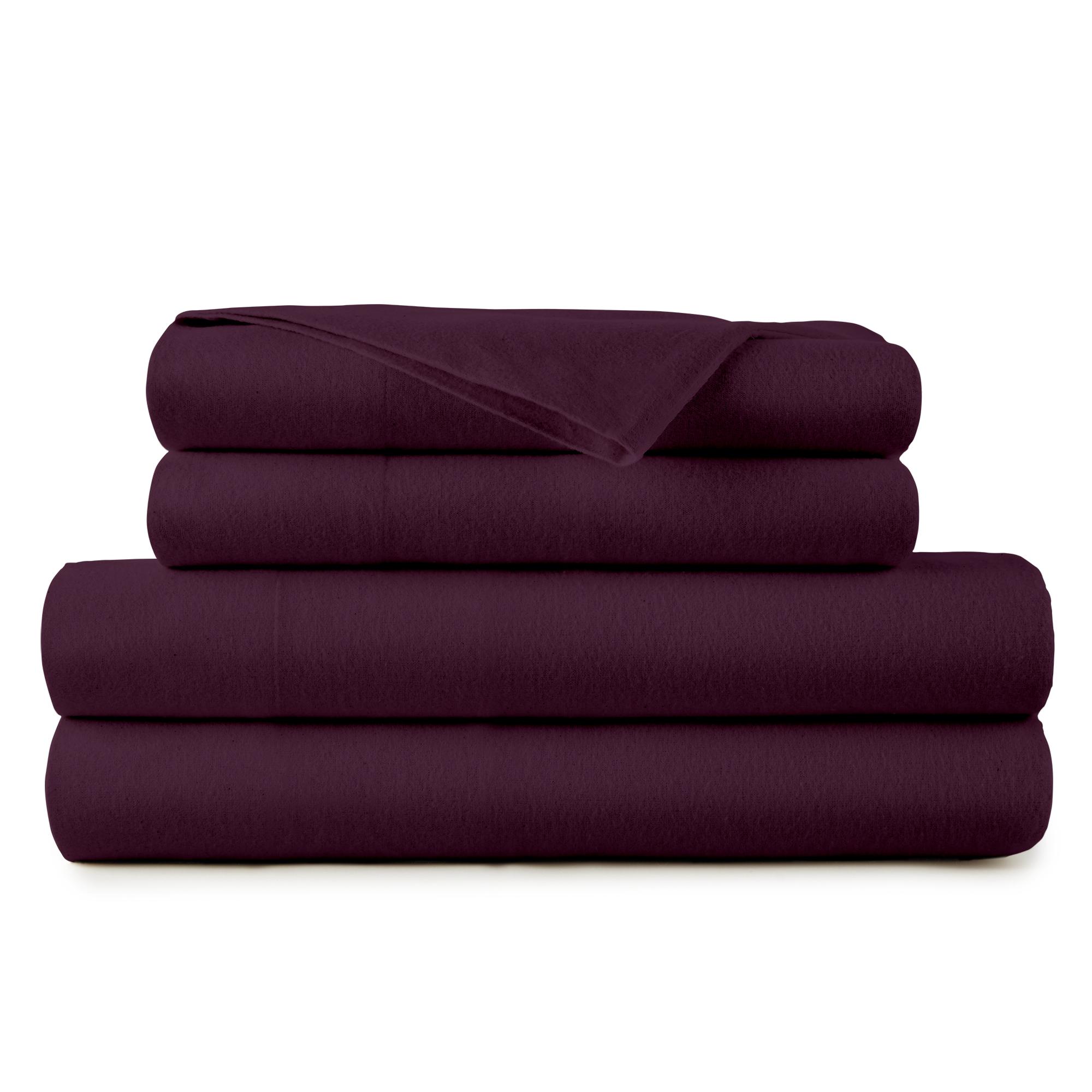 Stack of purple folded towels on a white background