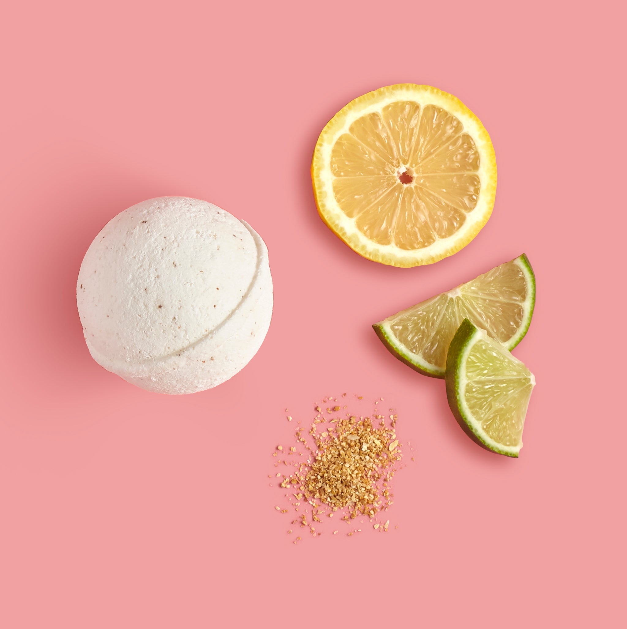 Bath bomb with lemon and lime slices on a pink background