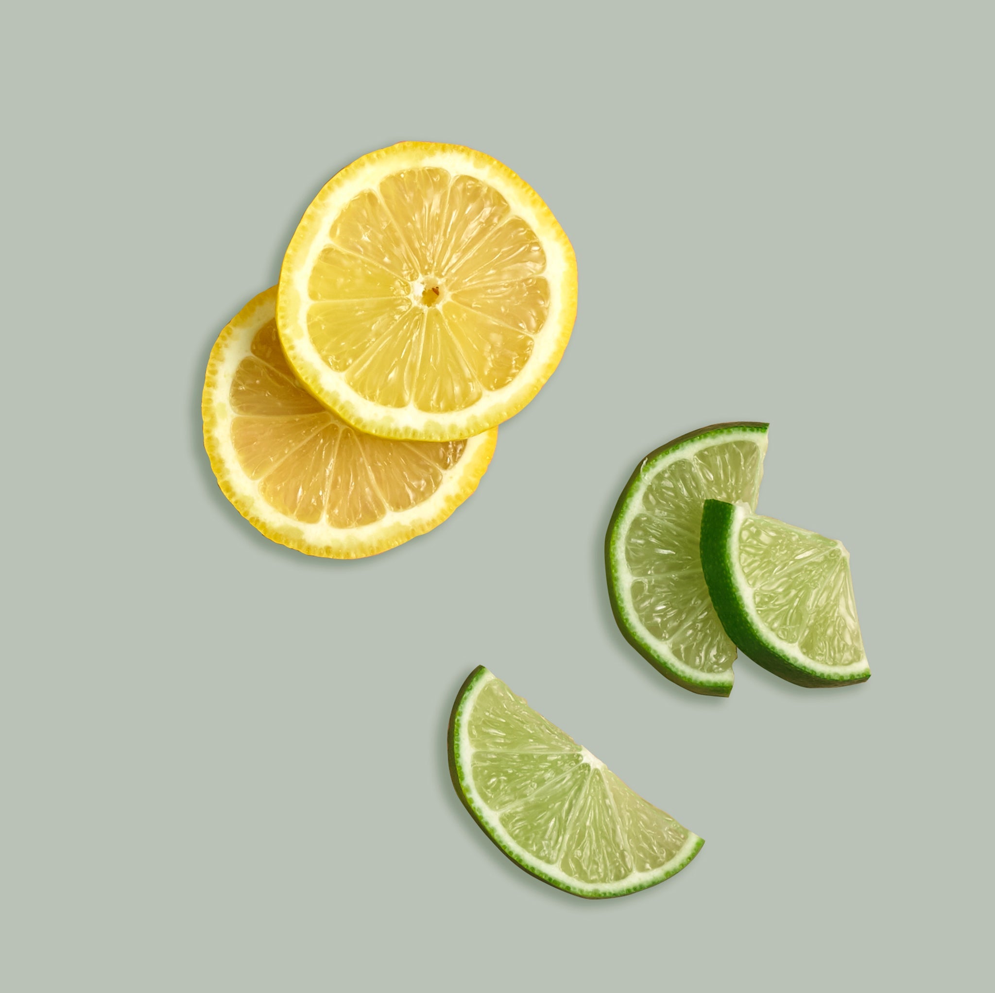 Sliced lemon and lime on a light gray background