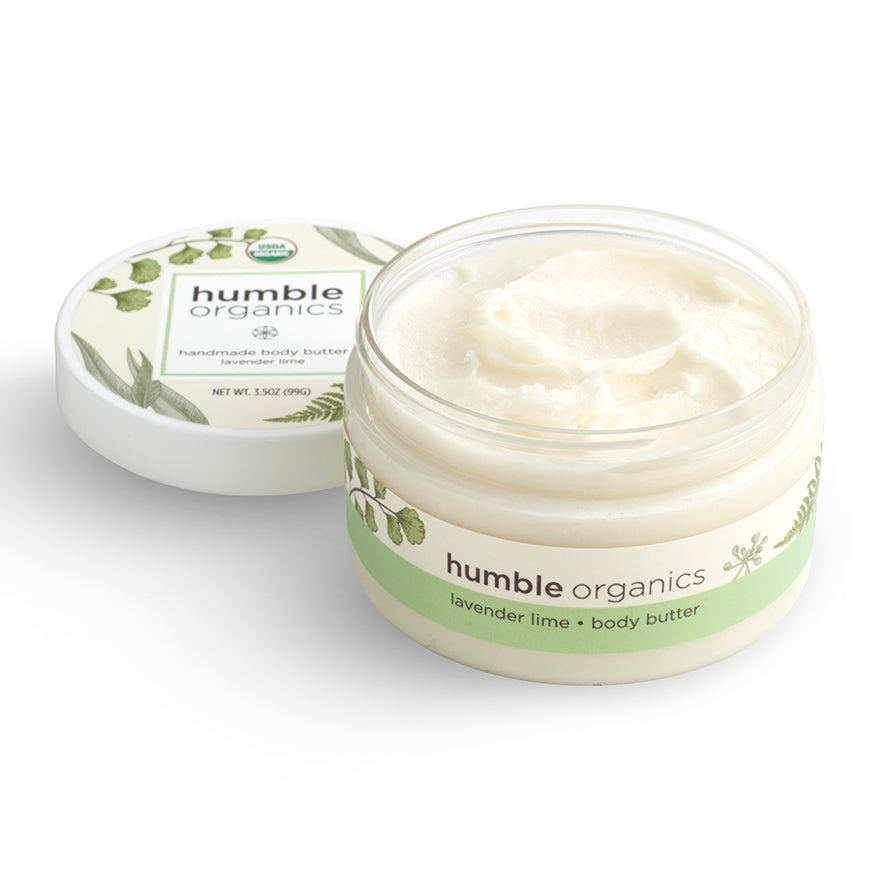 Jar of 'humble organics' body butter with lid on a white background