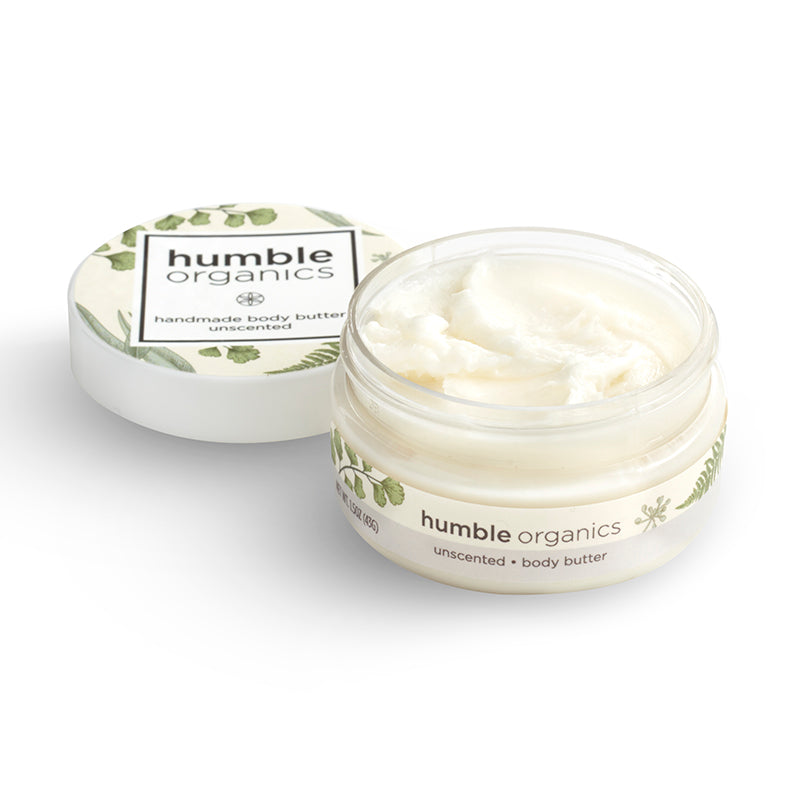 Two jars of 'humble organics' body butter on a white background