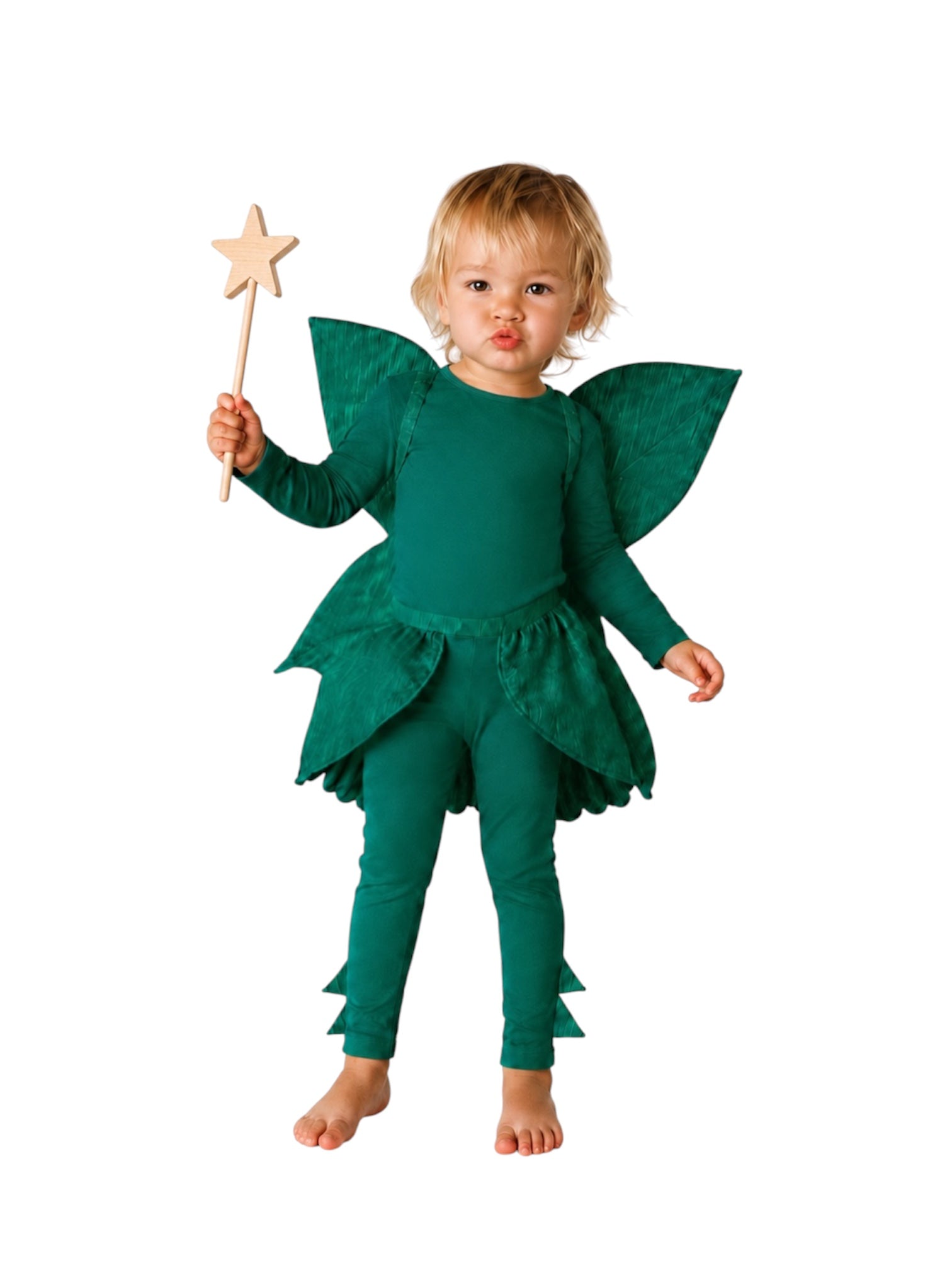 A toddler wearing a green fairy costume with matching leggings, leaf-shaped wings, and a star wand, standing against a plain white background.
