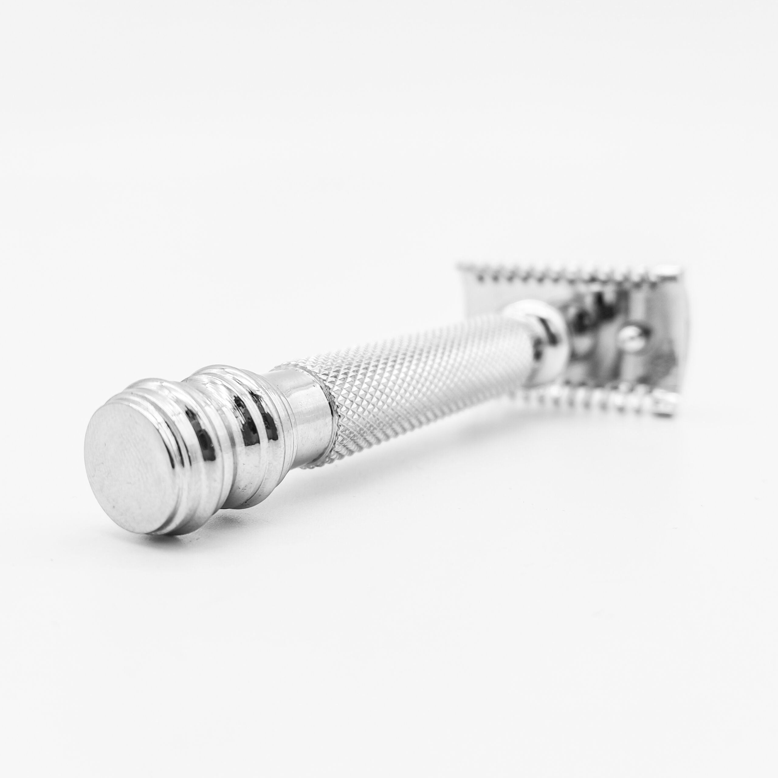 Silver safety razor on a white background