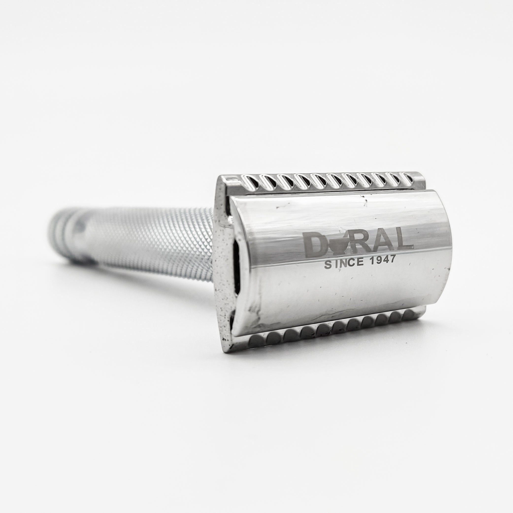 Silver DURAL safety razor on a white background