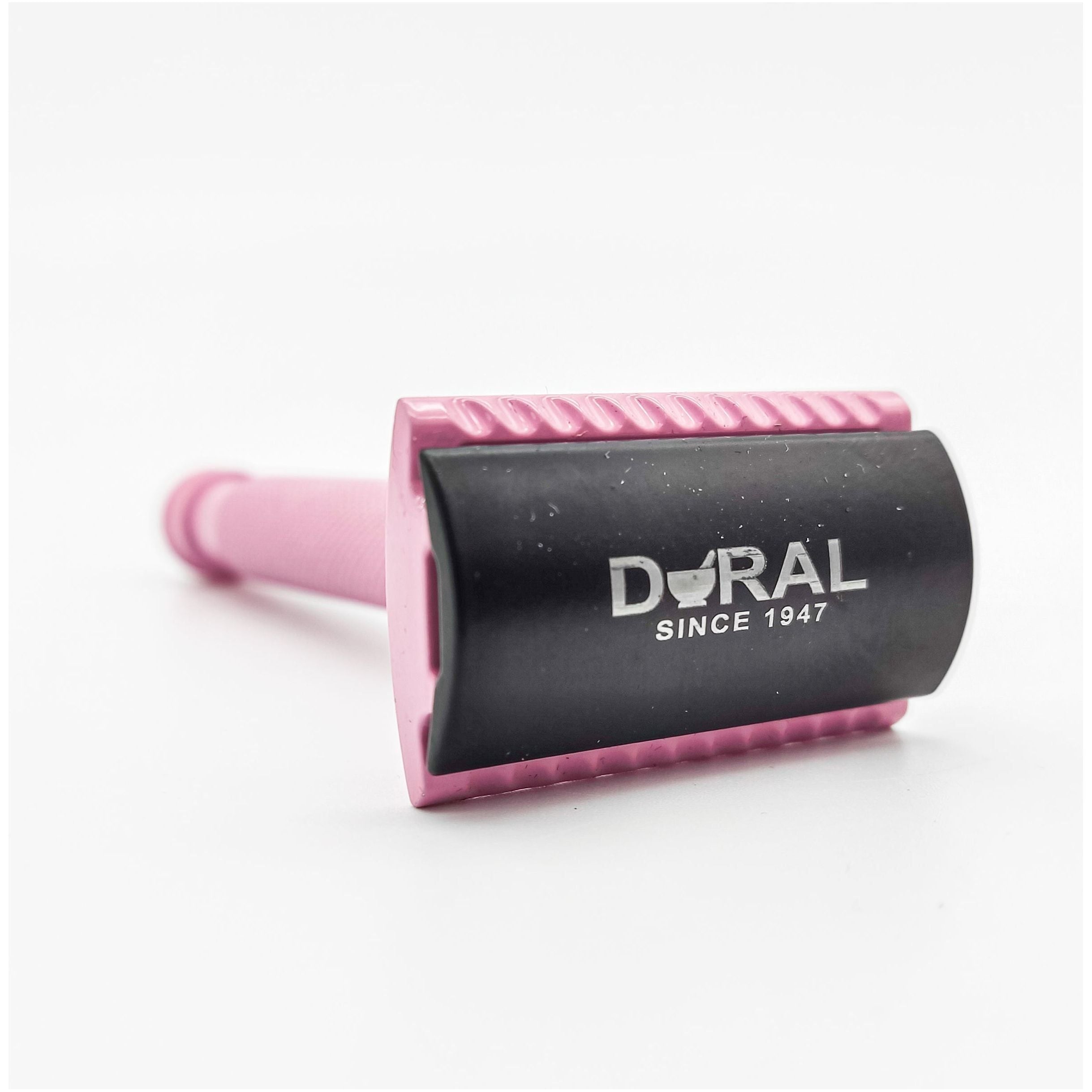 Pink and black Dural razor on a white background