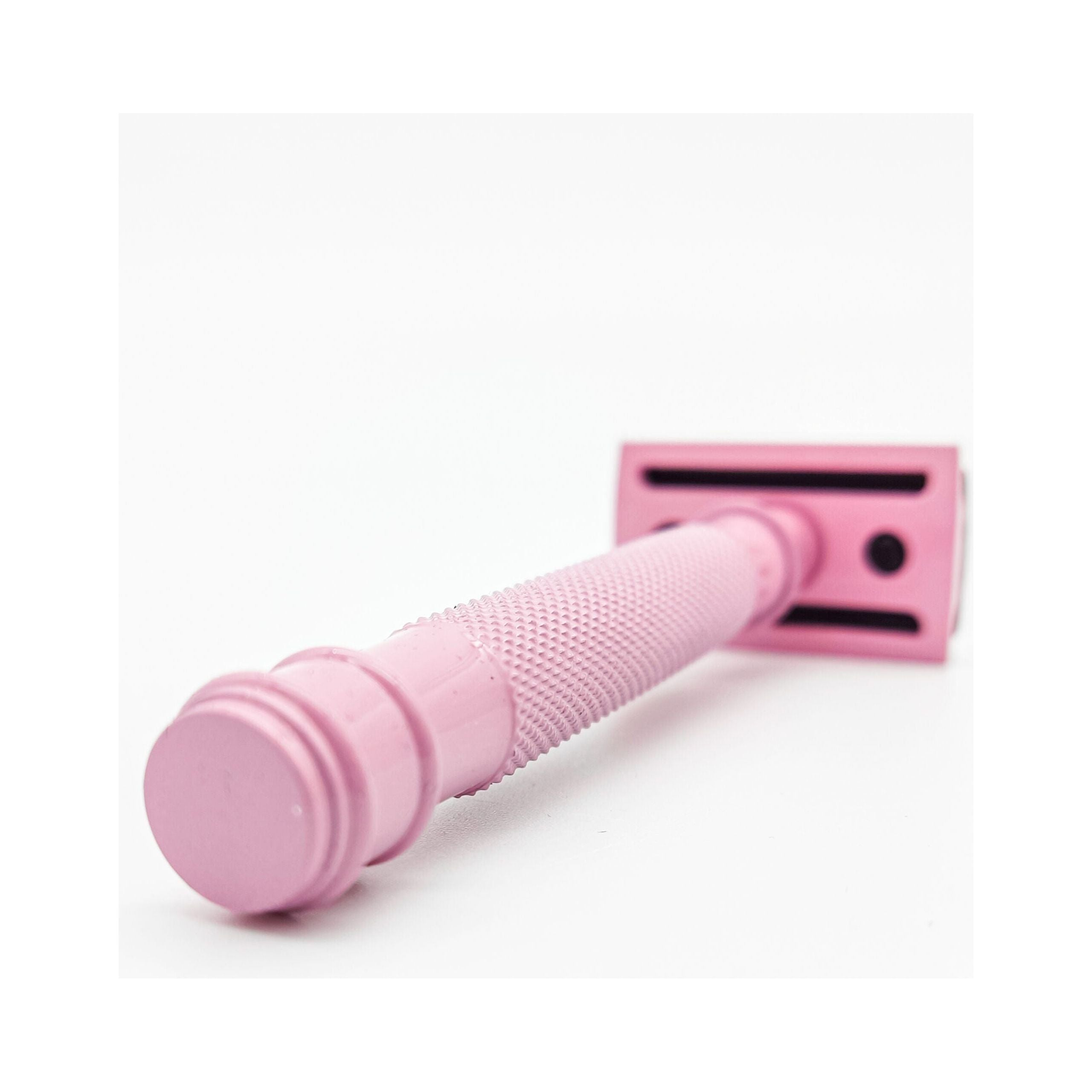 Pink handle of a razor on a white background