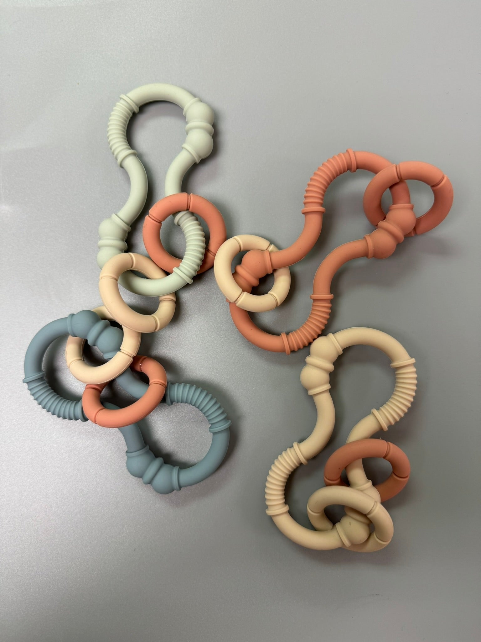 Colorful baby teething ring on a gray background