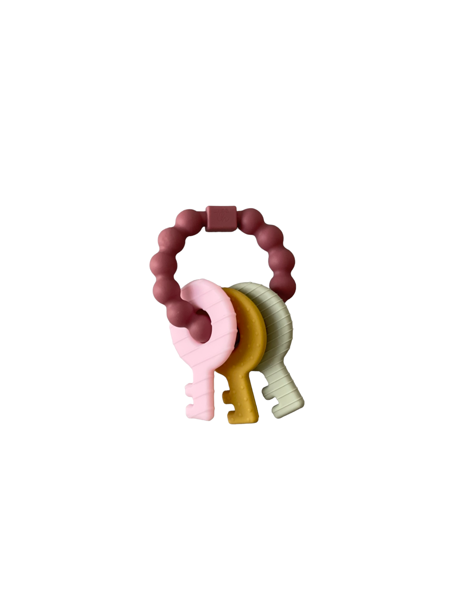 Teething ring with pink elephant, yellow key, and green dinosaur shapes on a white background