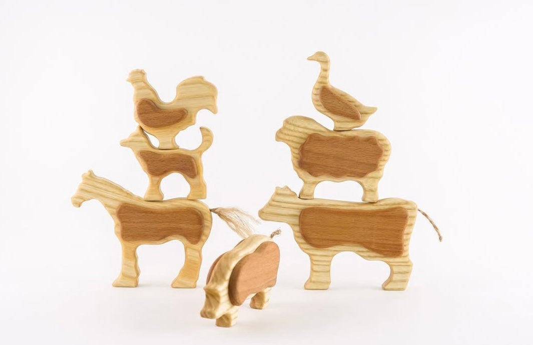 Set of wooden animal figurines on a white background