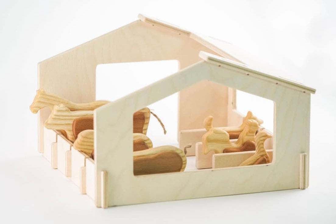 Wooden toy set with a small house and various wooden pieces on a white background