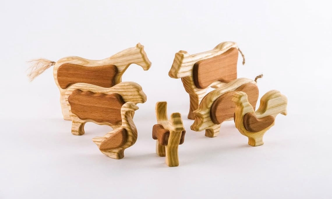 Wooden horse family figurines on a white background