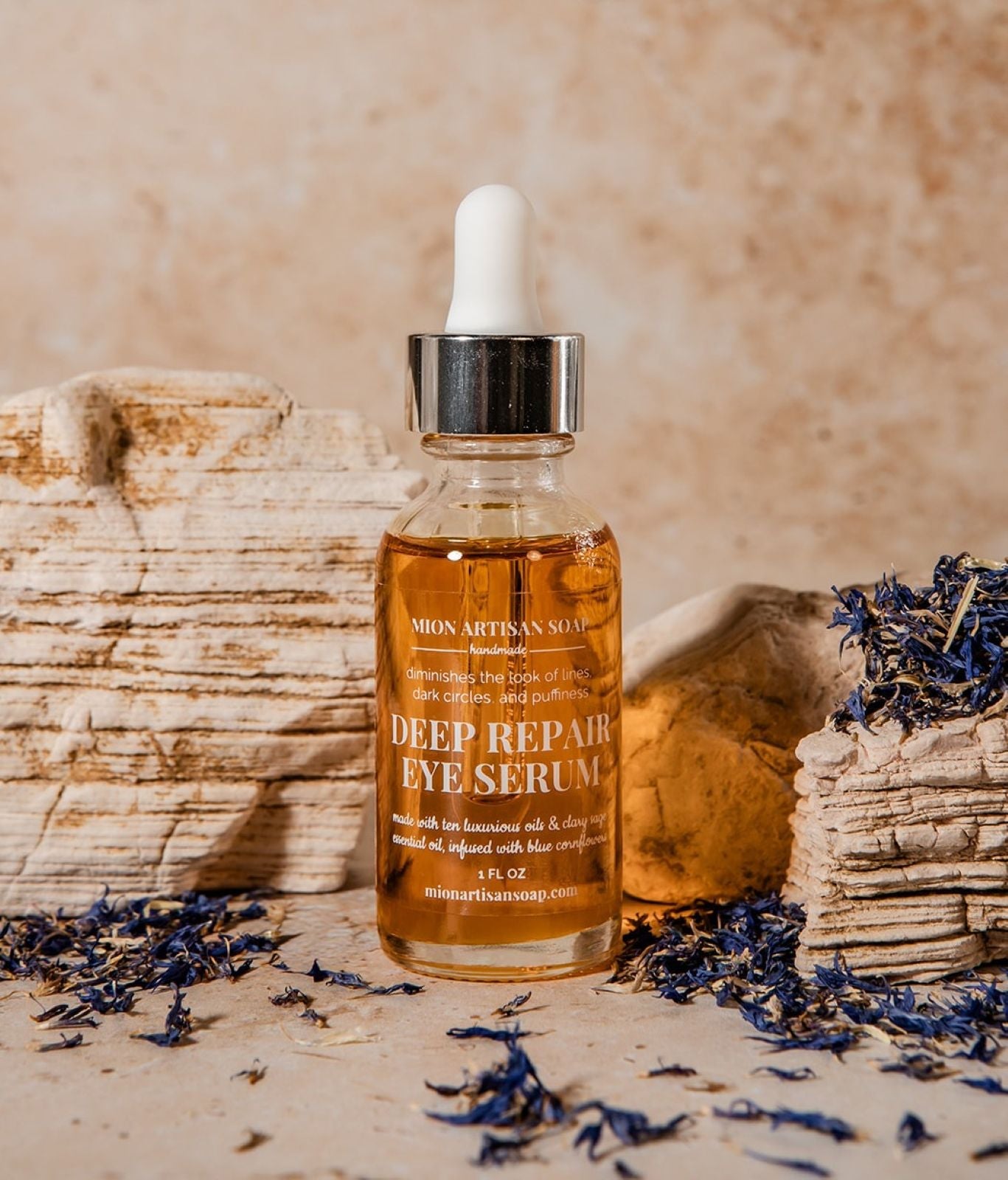 Bottle of deep repair eye serum with a dropper on a natural stone background