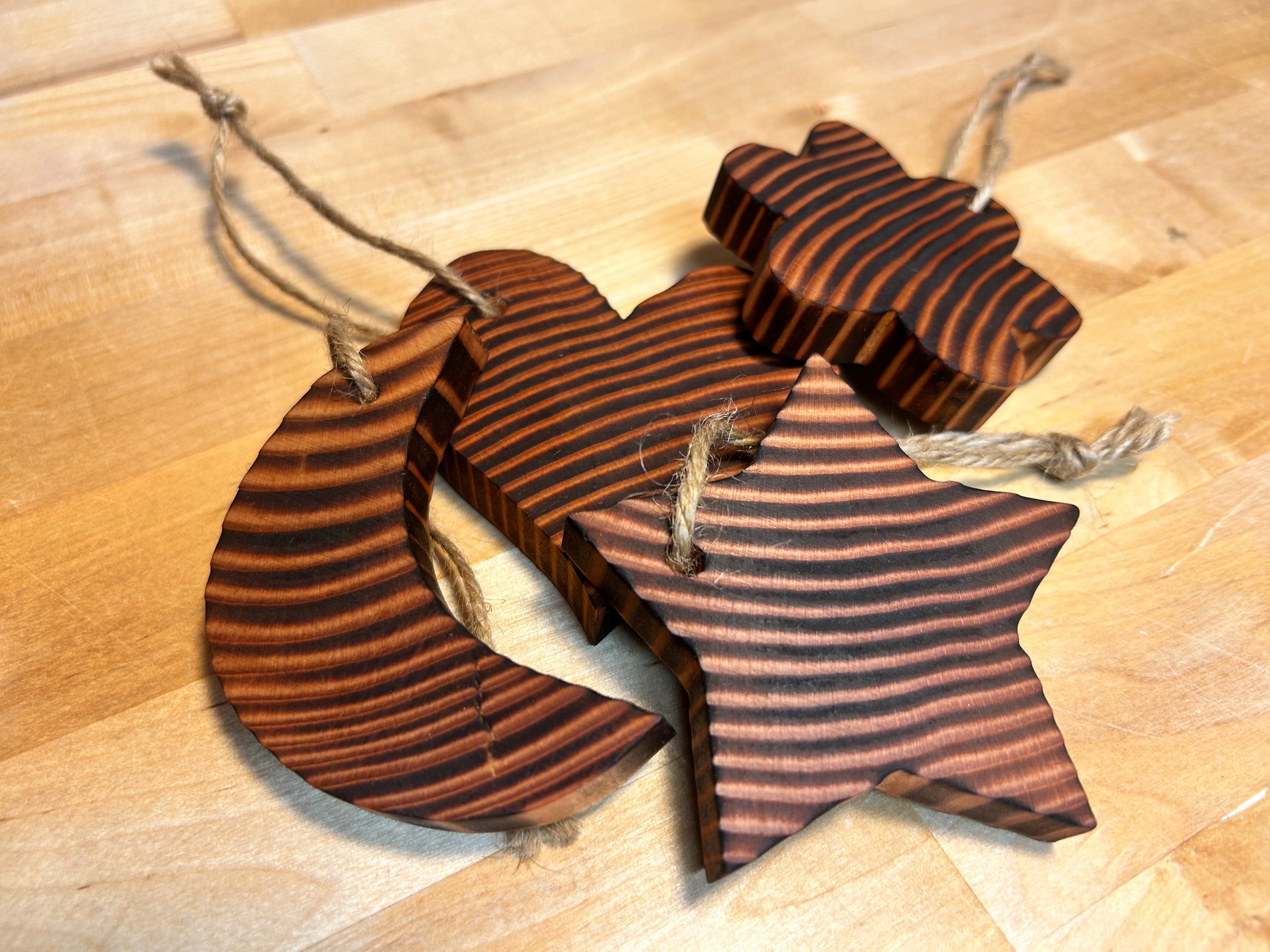 Wooden star, moon, flower, and heart ornaments handcrafted from Douglas Fir in Vermont.