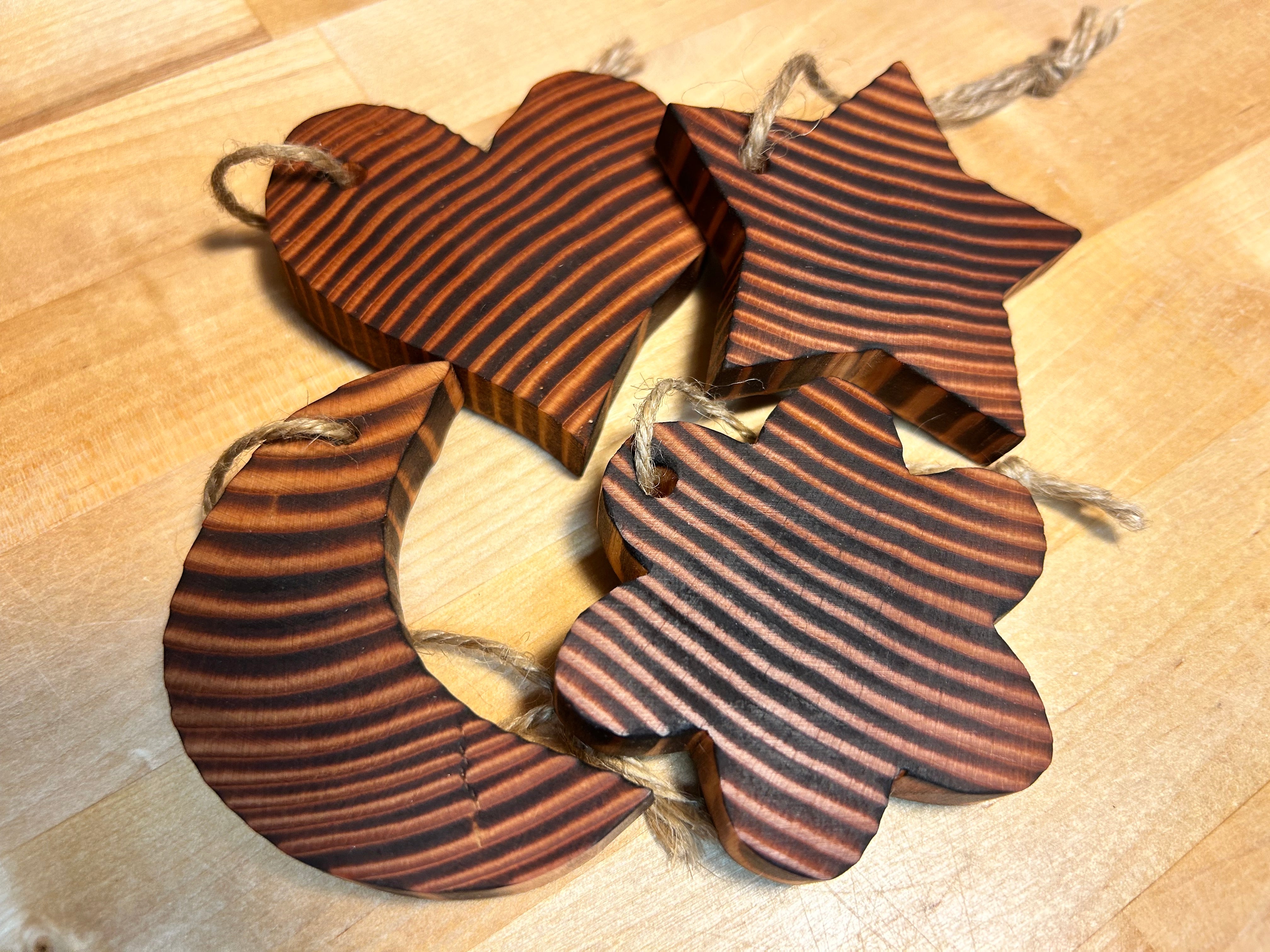 Wooden star, moon, flower, and heart ornaments handcrafted from Douglas Fir in Vermont.