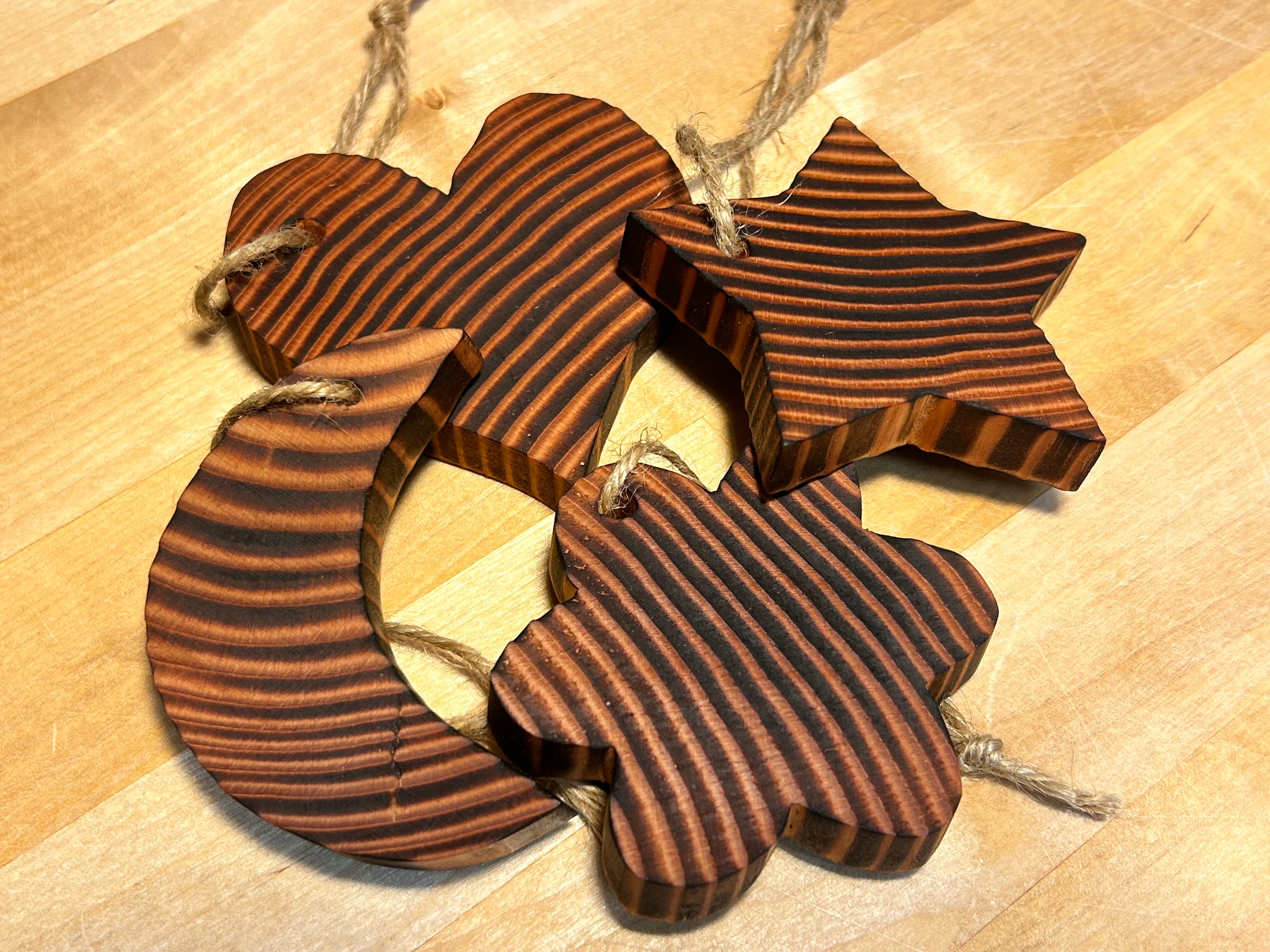 Wooden star, moon, flower, and heart ornaments handcrafted from Douglas Fir in Vermont.