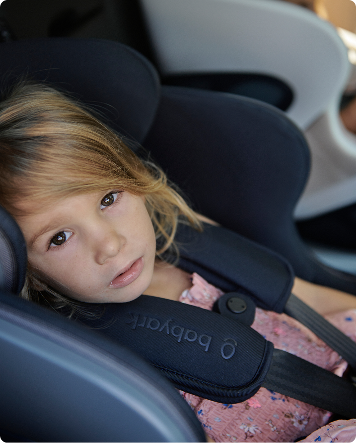 Child in a car seat with 'Babyark' branding