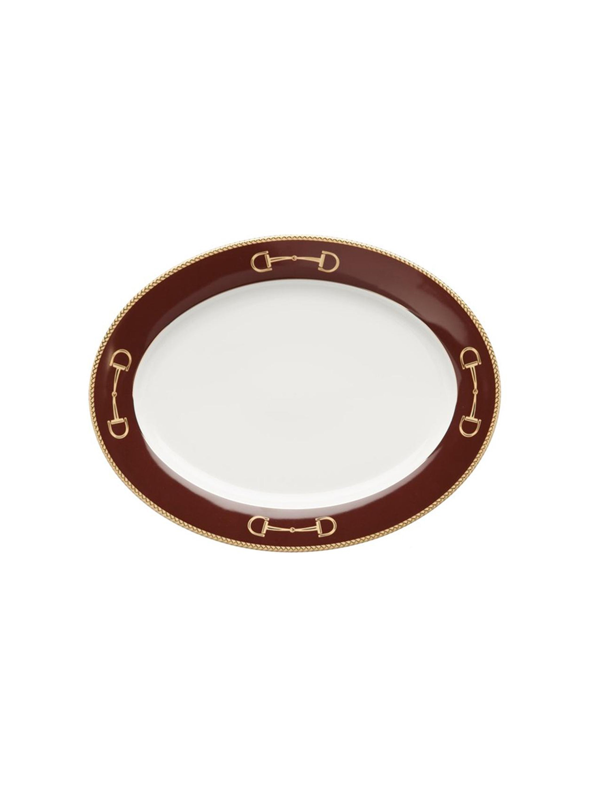White plate with a red rim and gold horse bit design on a white background