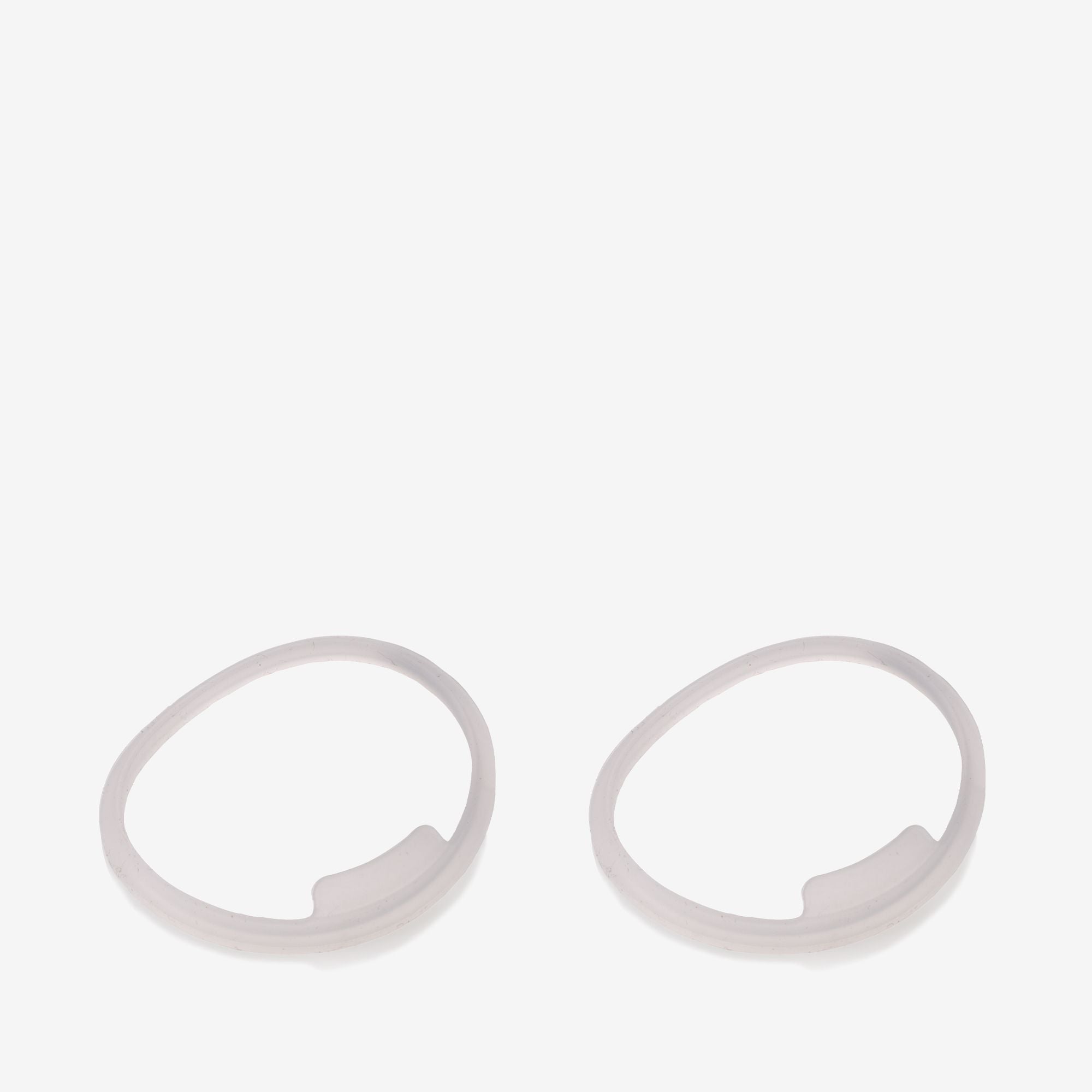 Two white circular objects on a light gray background