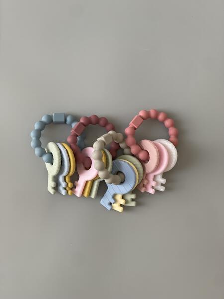 Set of colorful baby teething rings on a plain background