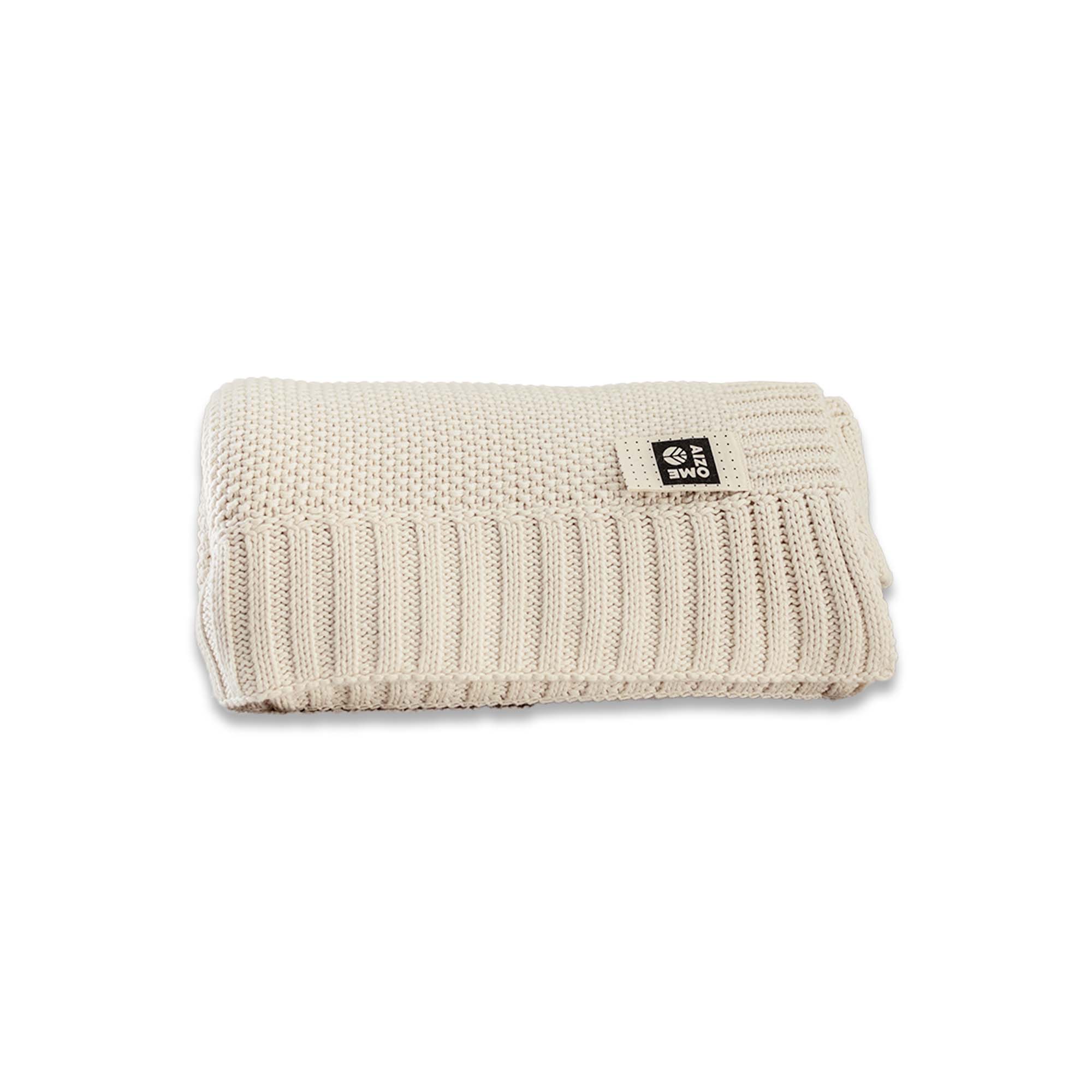 Beige knitted blanket with a brand label on a white background