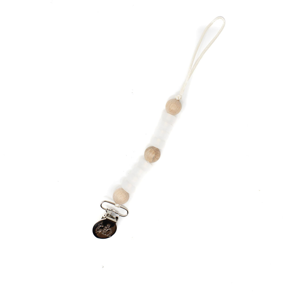 White pacifier clip with wooden beads on a white background