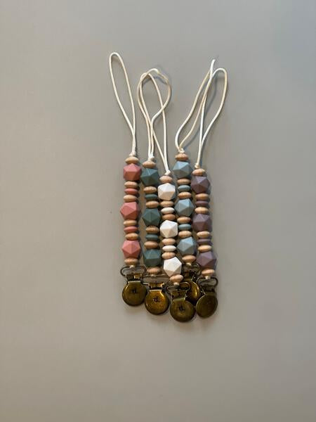 Set of three beaded keychains with metal loops on a gray background
