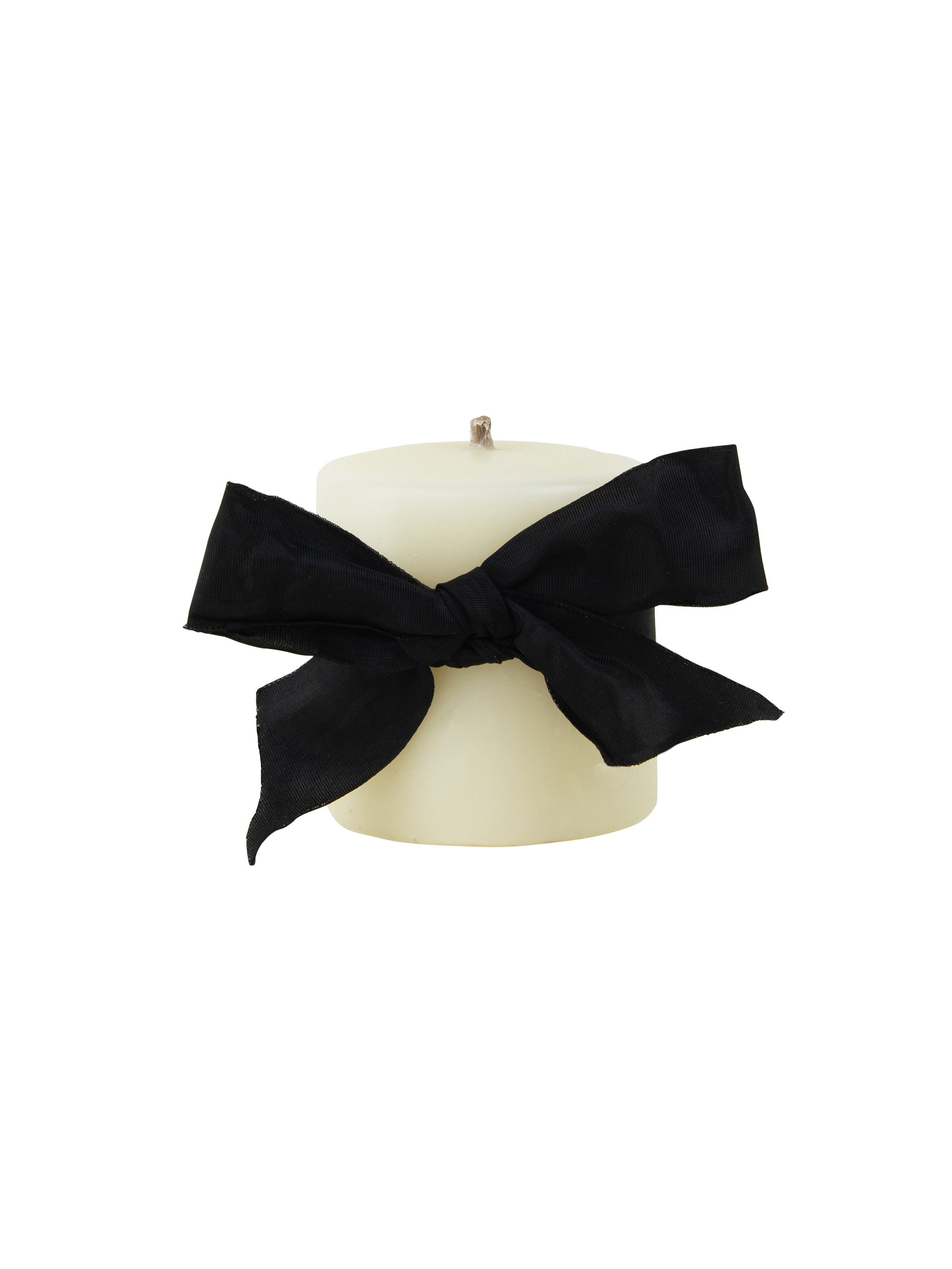 White candle with a black ribbon on a white background