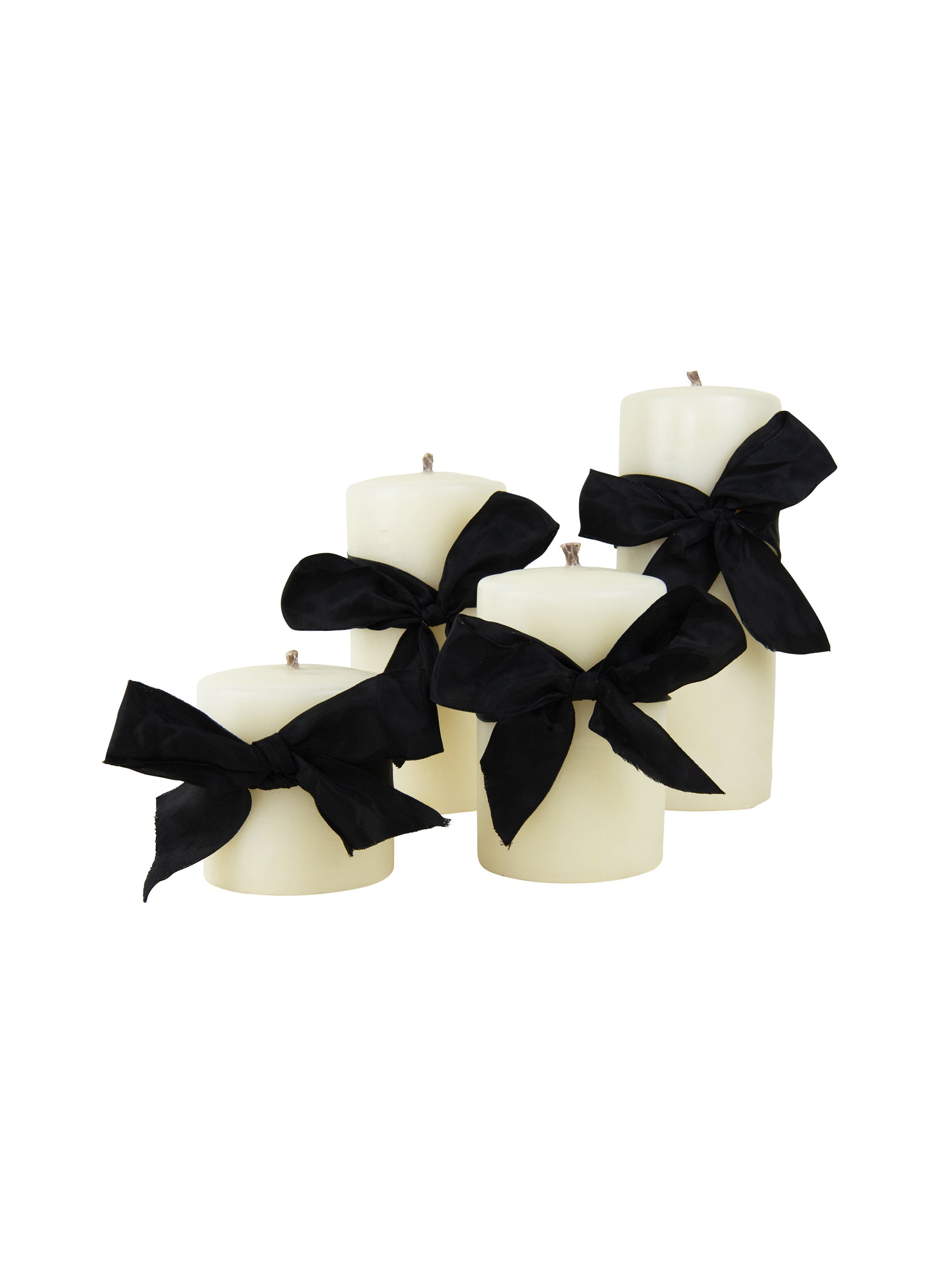 White candles with black ribbons on a white background