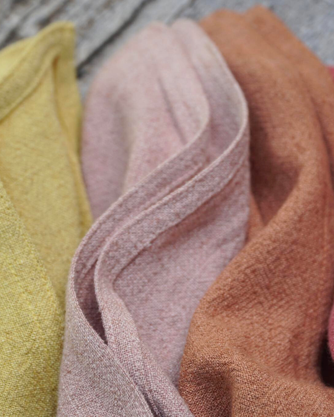 Close-up of textured fabric in yellow, pink, and brown.