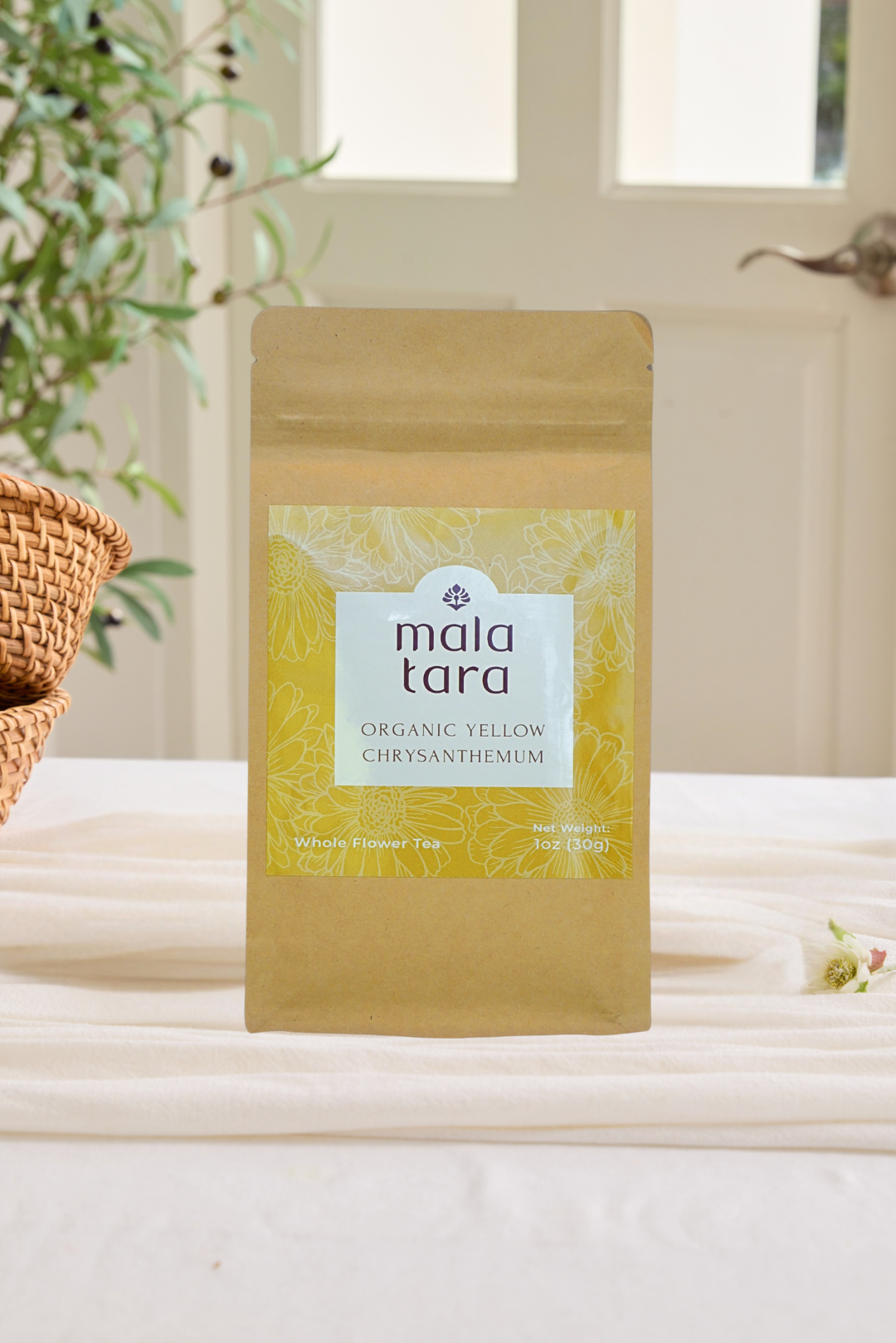 Mala Tara organic yellow chrysanthemum package on a light surface with a blurred natural background