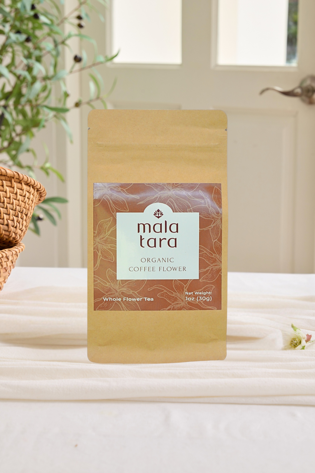 Mala Tara organic coffee flower package on a light surface with a blurred indoor background