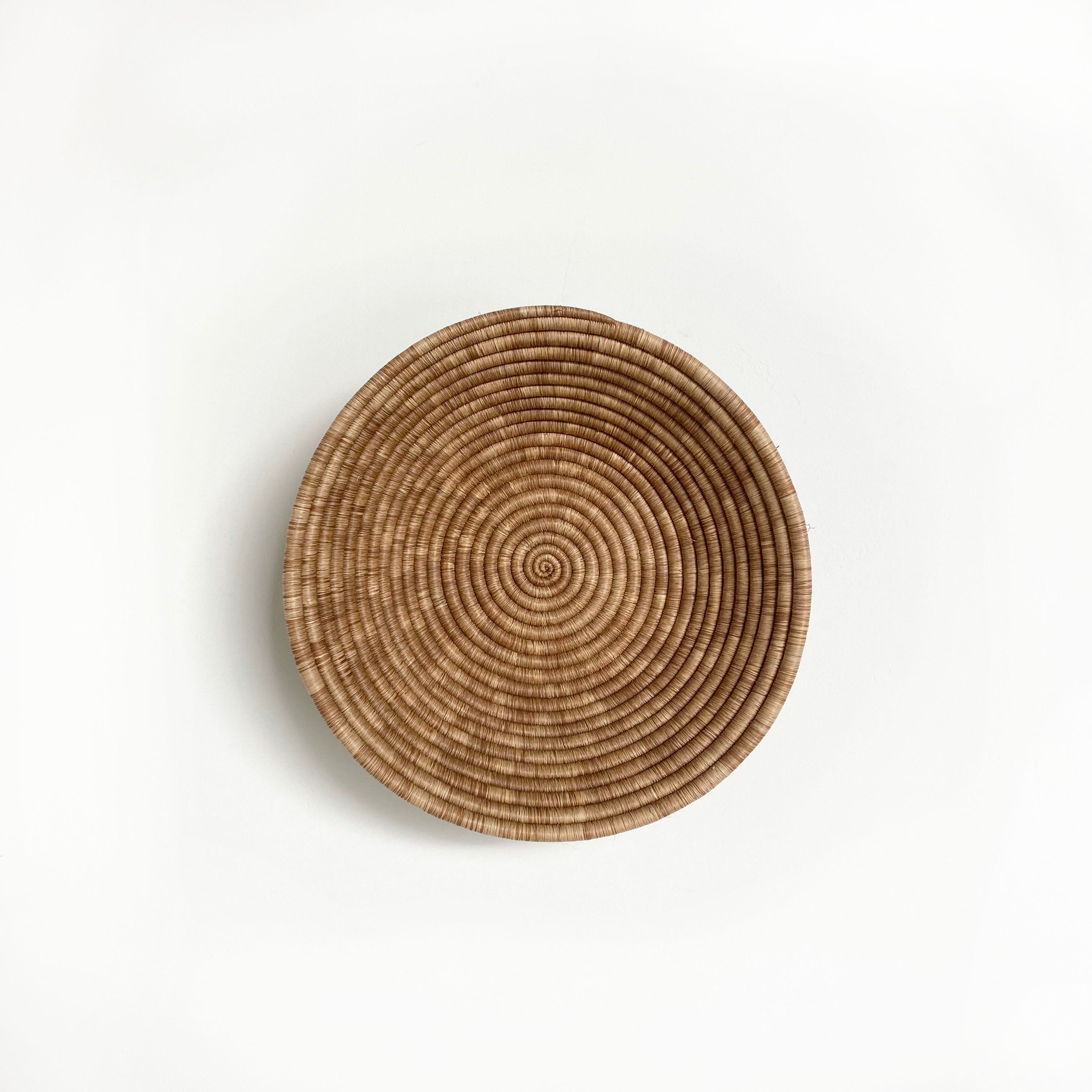 Round woven basket on a light gray background
