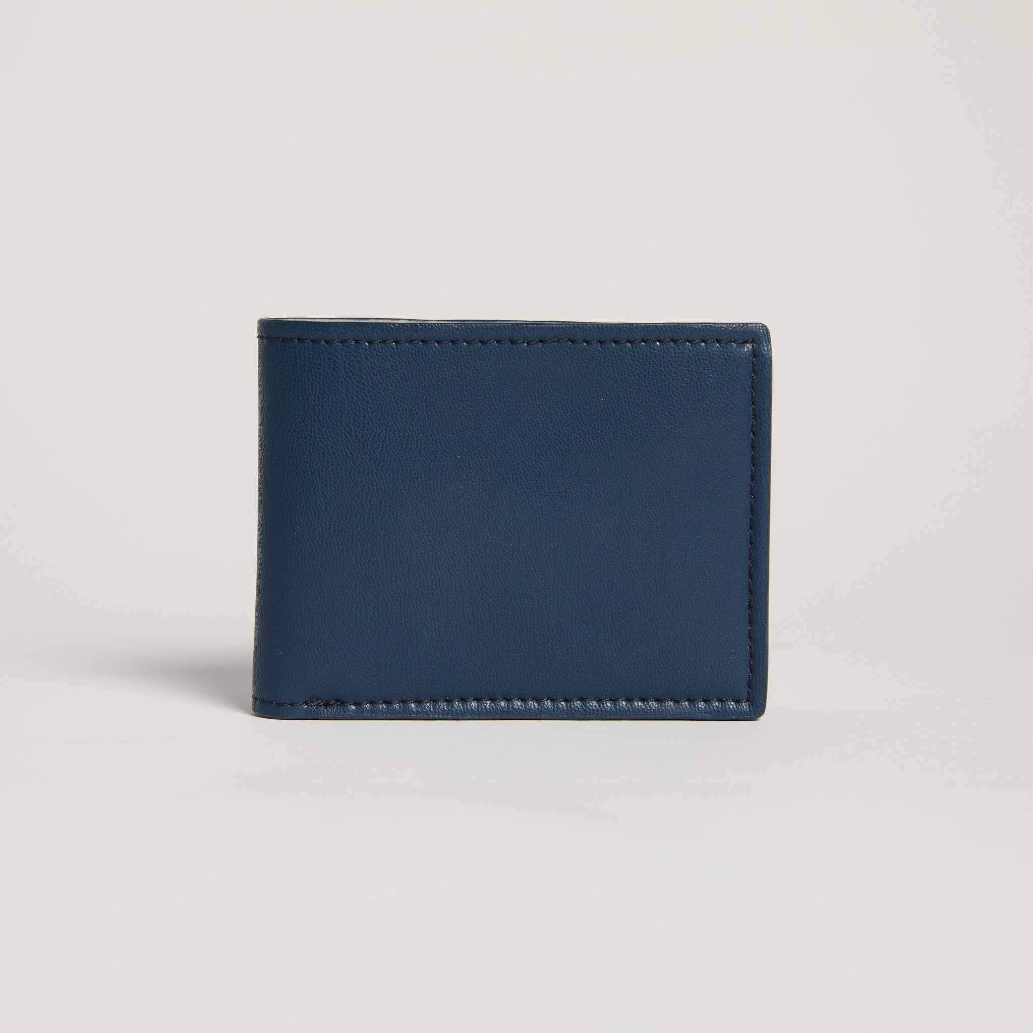 Navy blue leather wallet on a light gray background