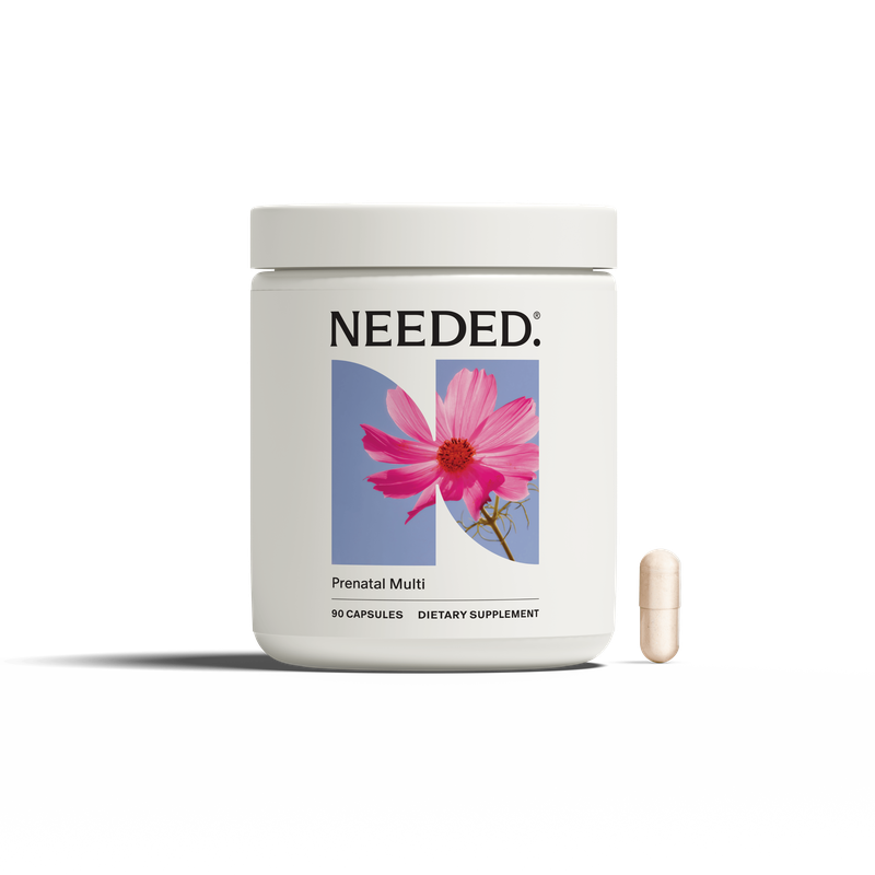 Supplement container labeled 'NEEDED' with a pink flower on a white background
