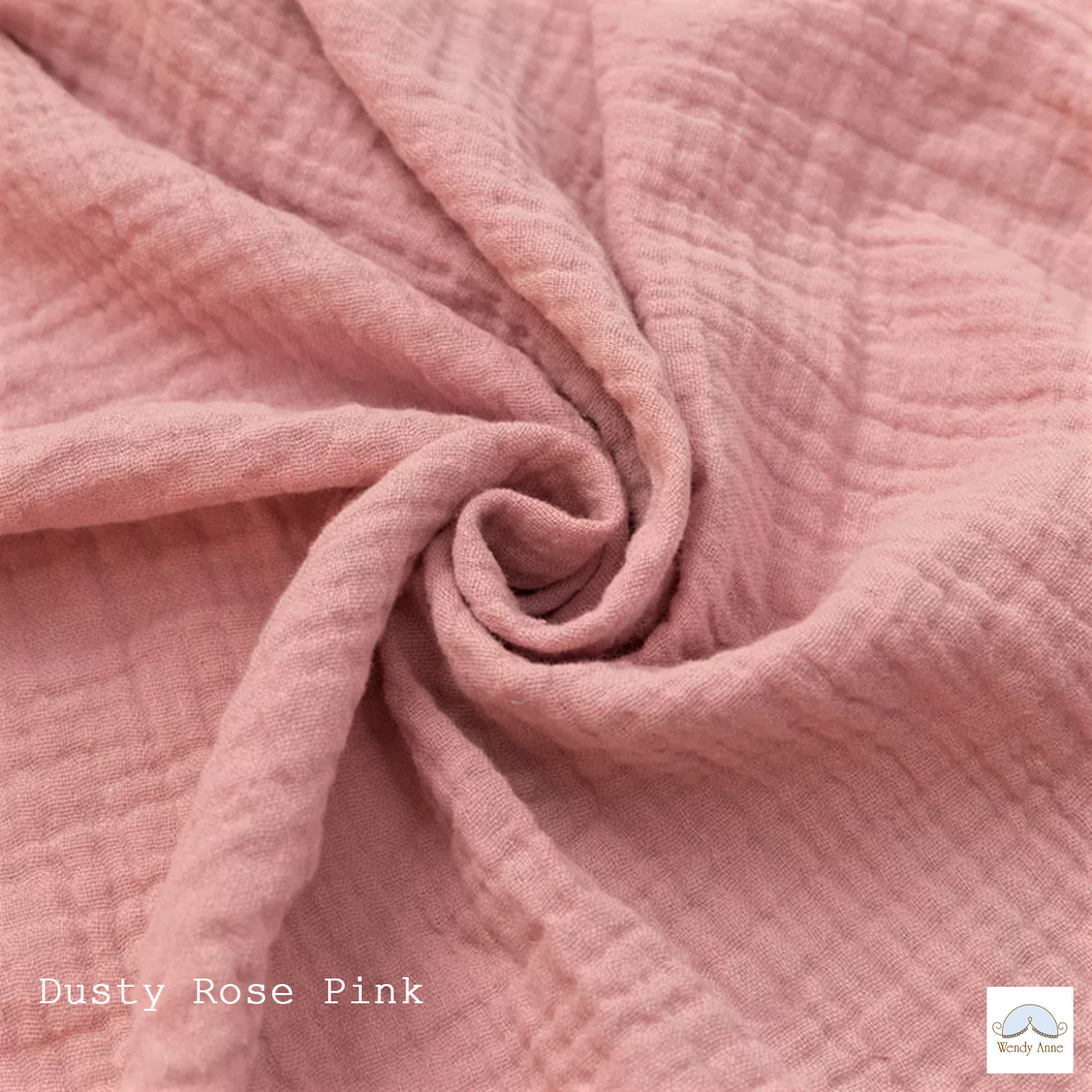Close-up of pink fabric with a visible brand logo in the corner.