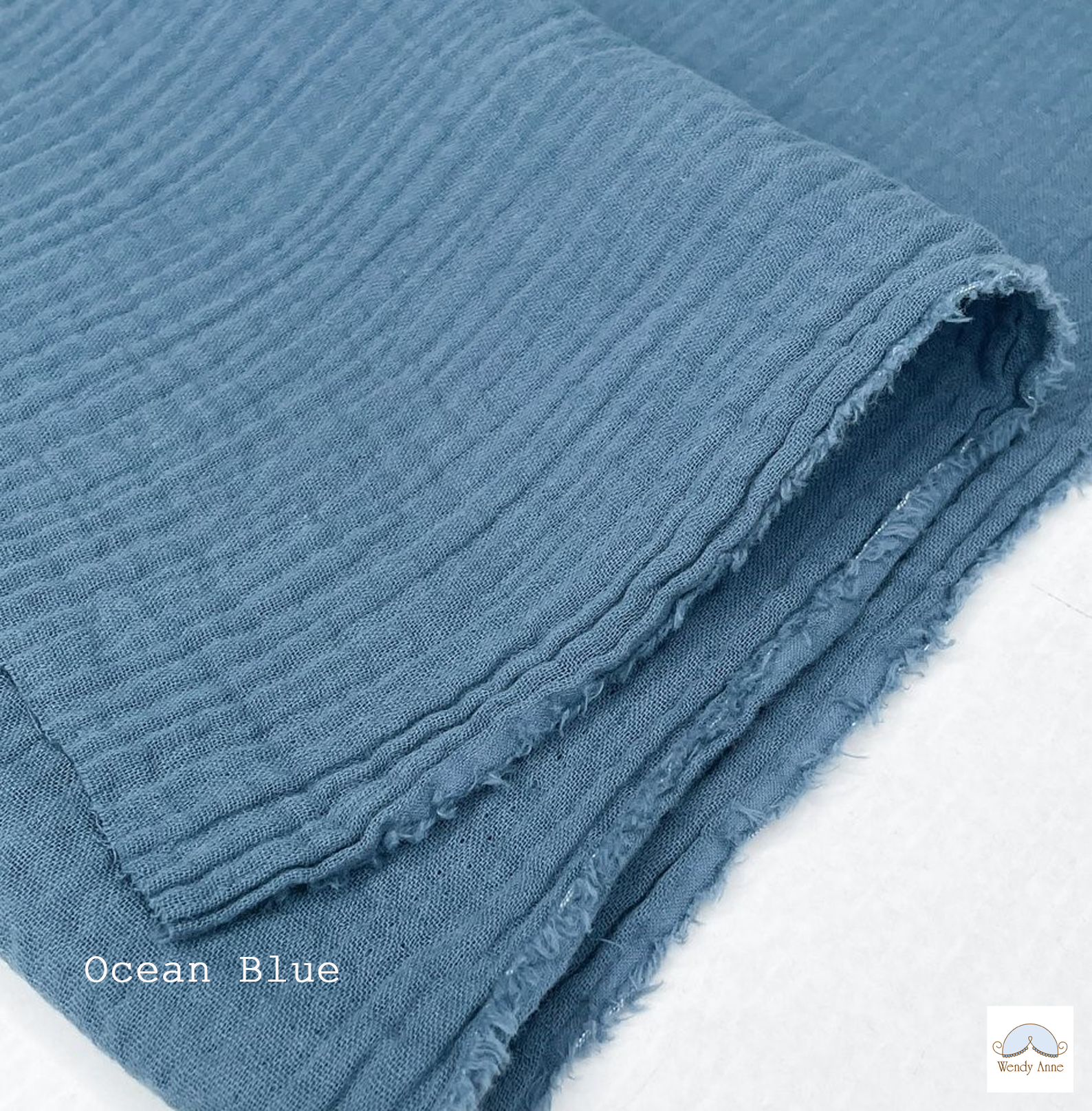Folded blue fabric with 'Ocean Blue' label on a white background