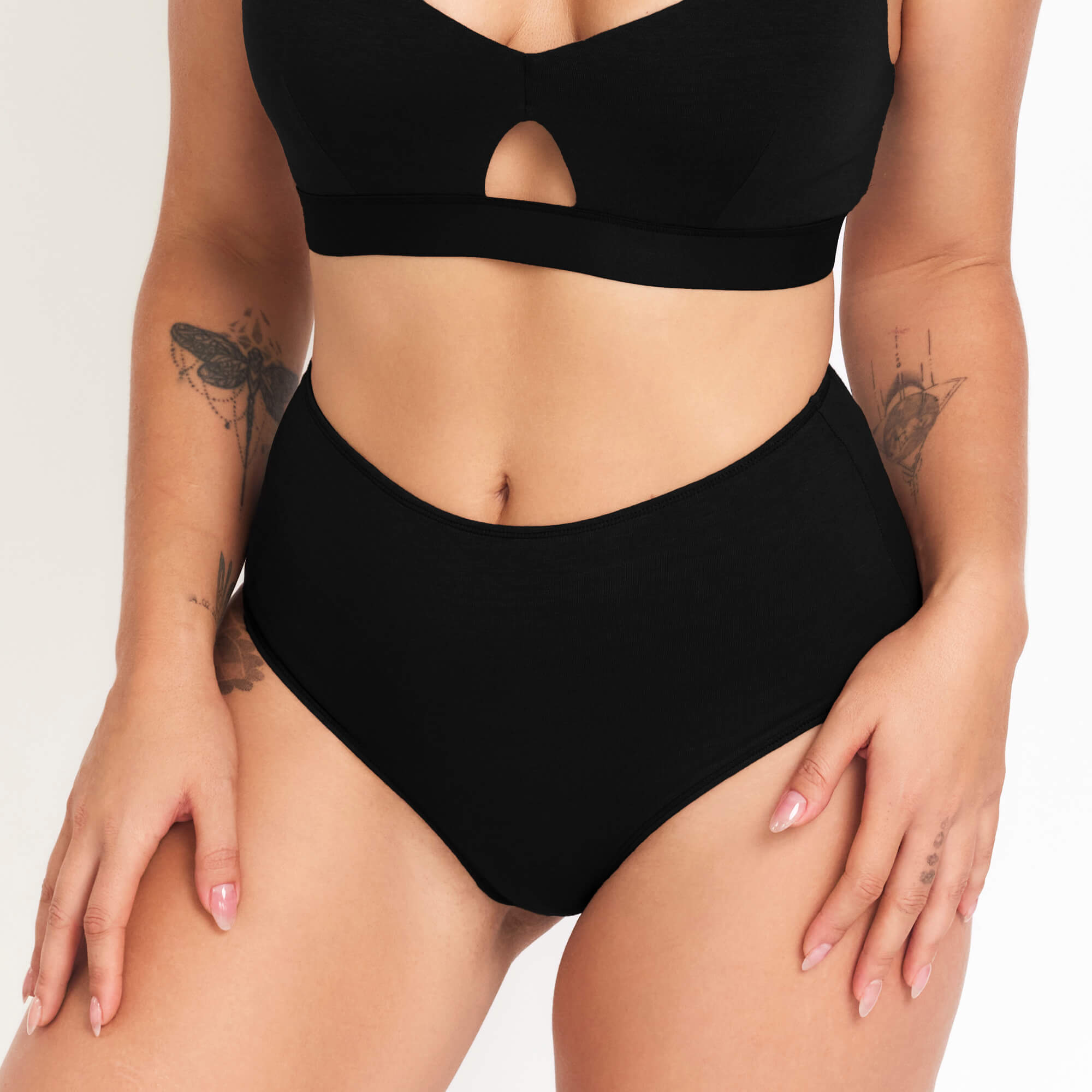 Person wearing a black bikini set on a plain background