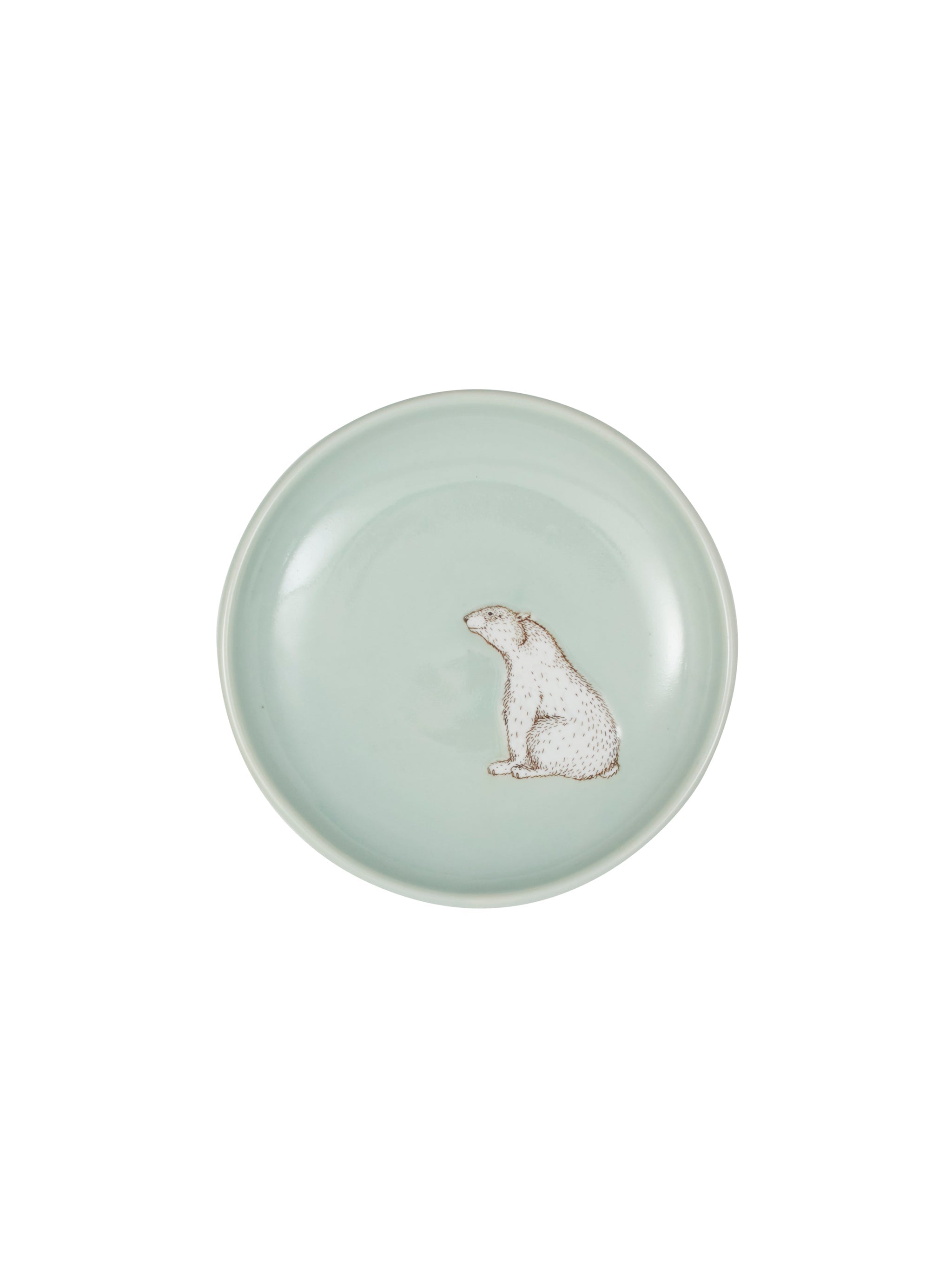 Round ceramic plate with a polar bear design on a light green background