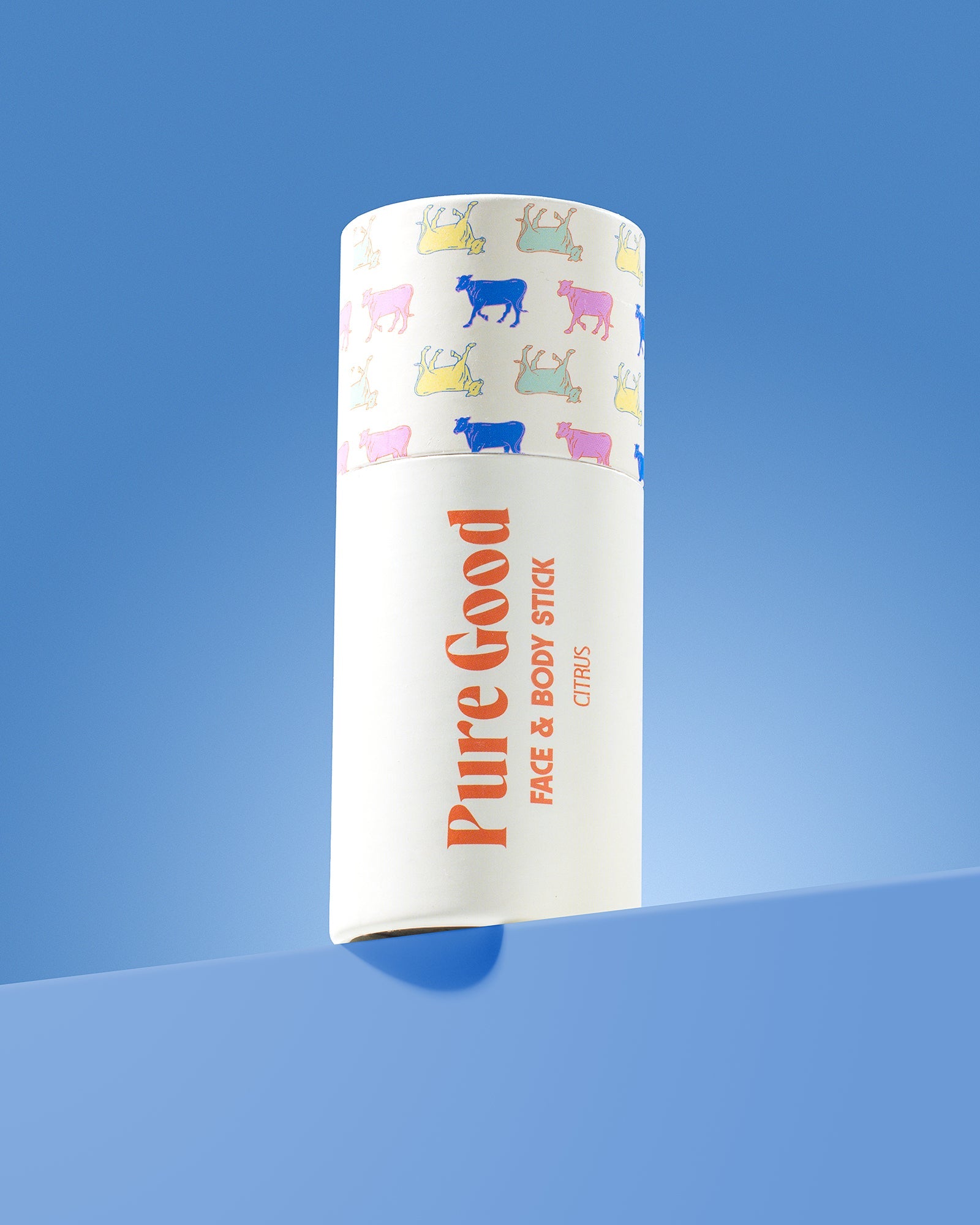  cylindrical product packaging with 'Pure Good' branding on a blue background