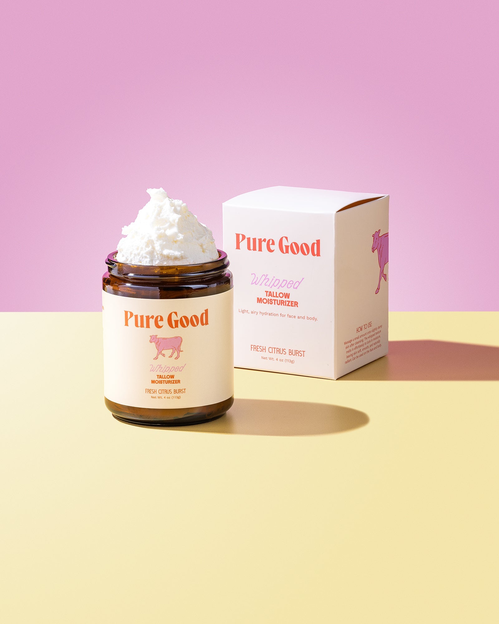Jar of whipped cream with 'Pure Good' branding on a pink and yellow gradient background