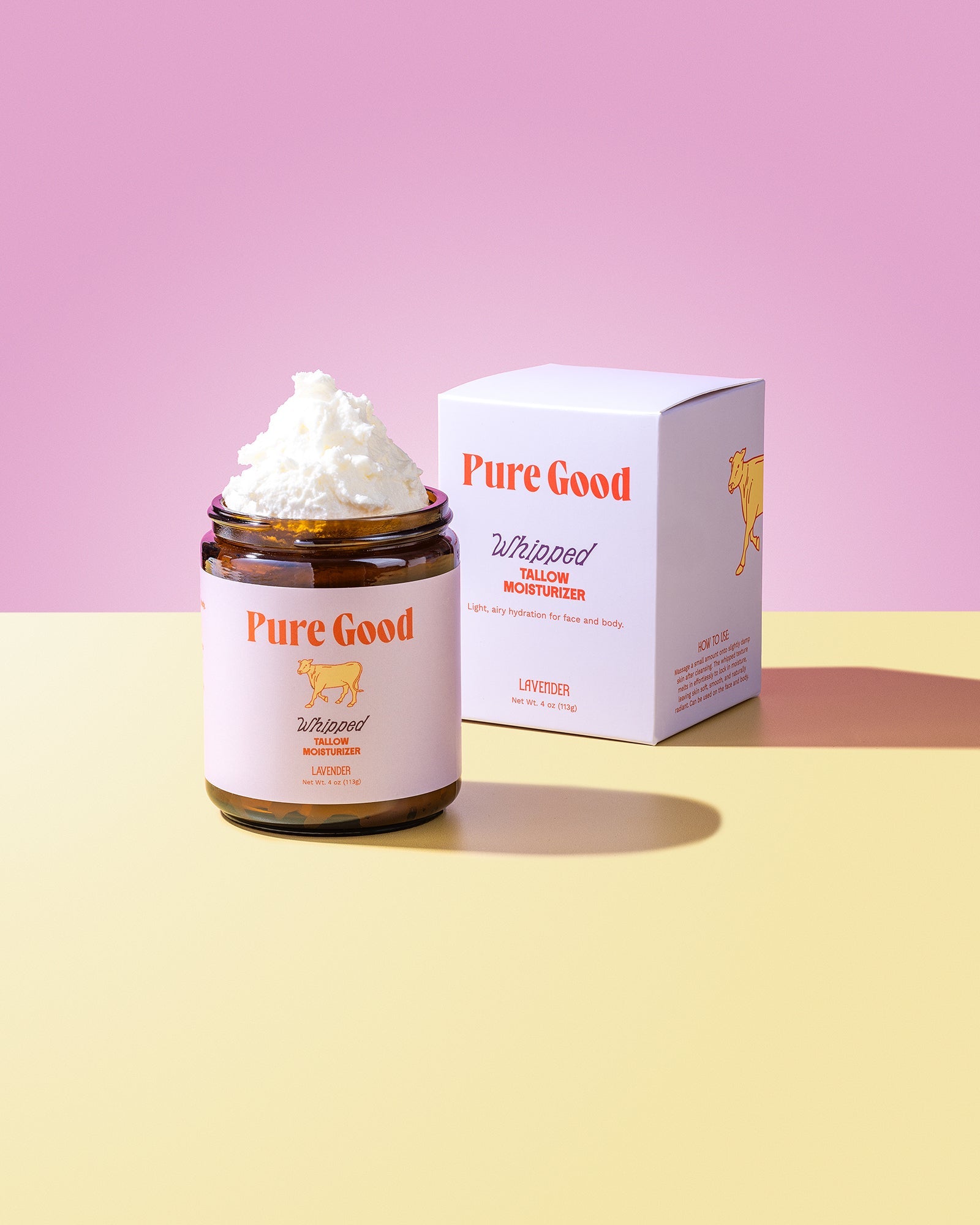 Jar of 'Pure Good' whipped cream with a box on a pink and yellow gradient background