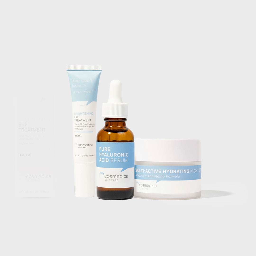 Cosmetic products including a serum, cream, and bottle on a light gray background